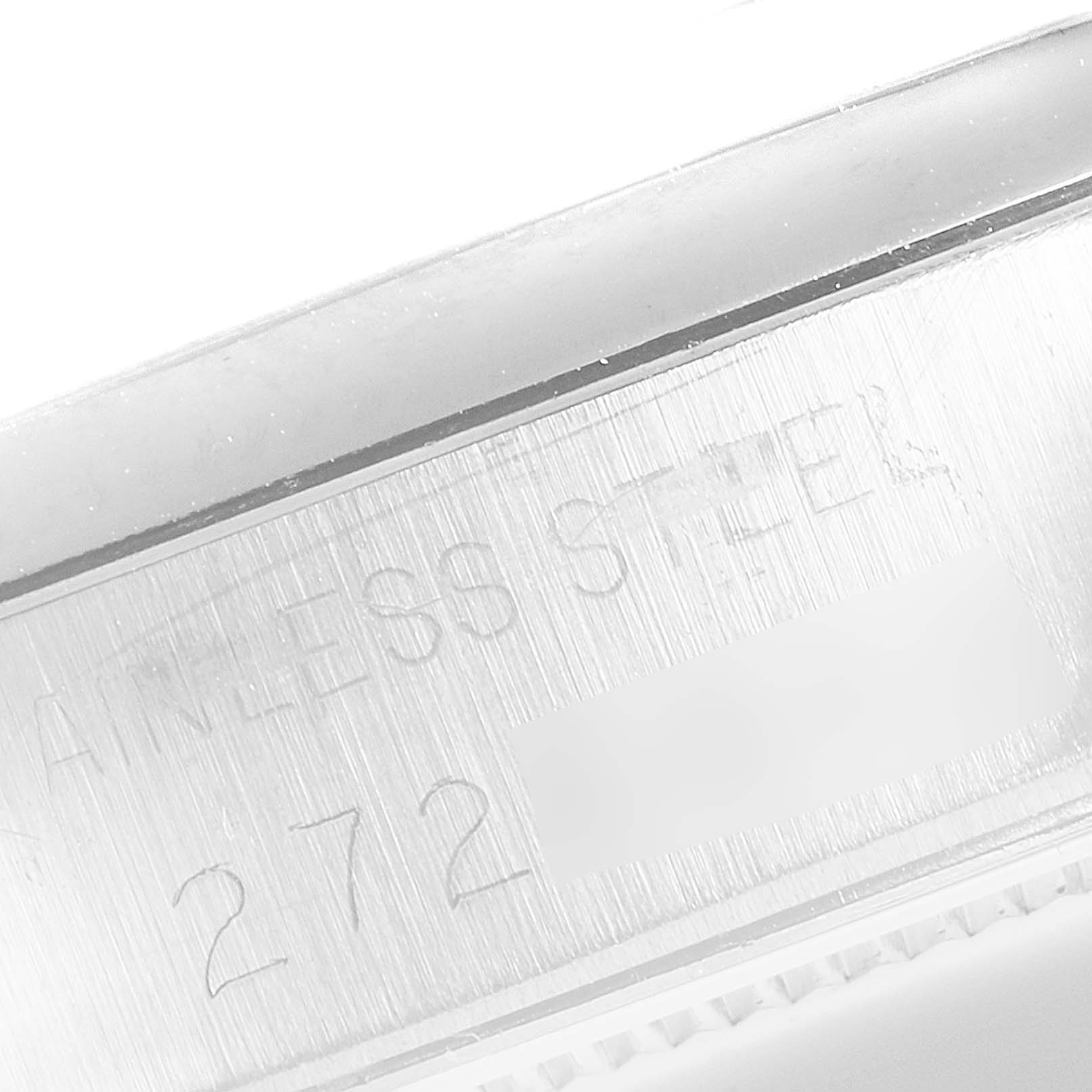 The image shows a close-up of the side of the Rolex Vintage Collection 6694 Men's Stainless Steel Black Dial 6694 Men's Stainless Steel Black Dial watch case, highlighting the stainless steel material and partial serial number.