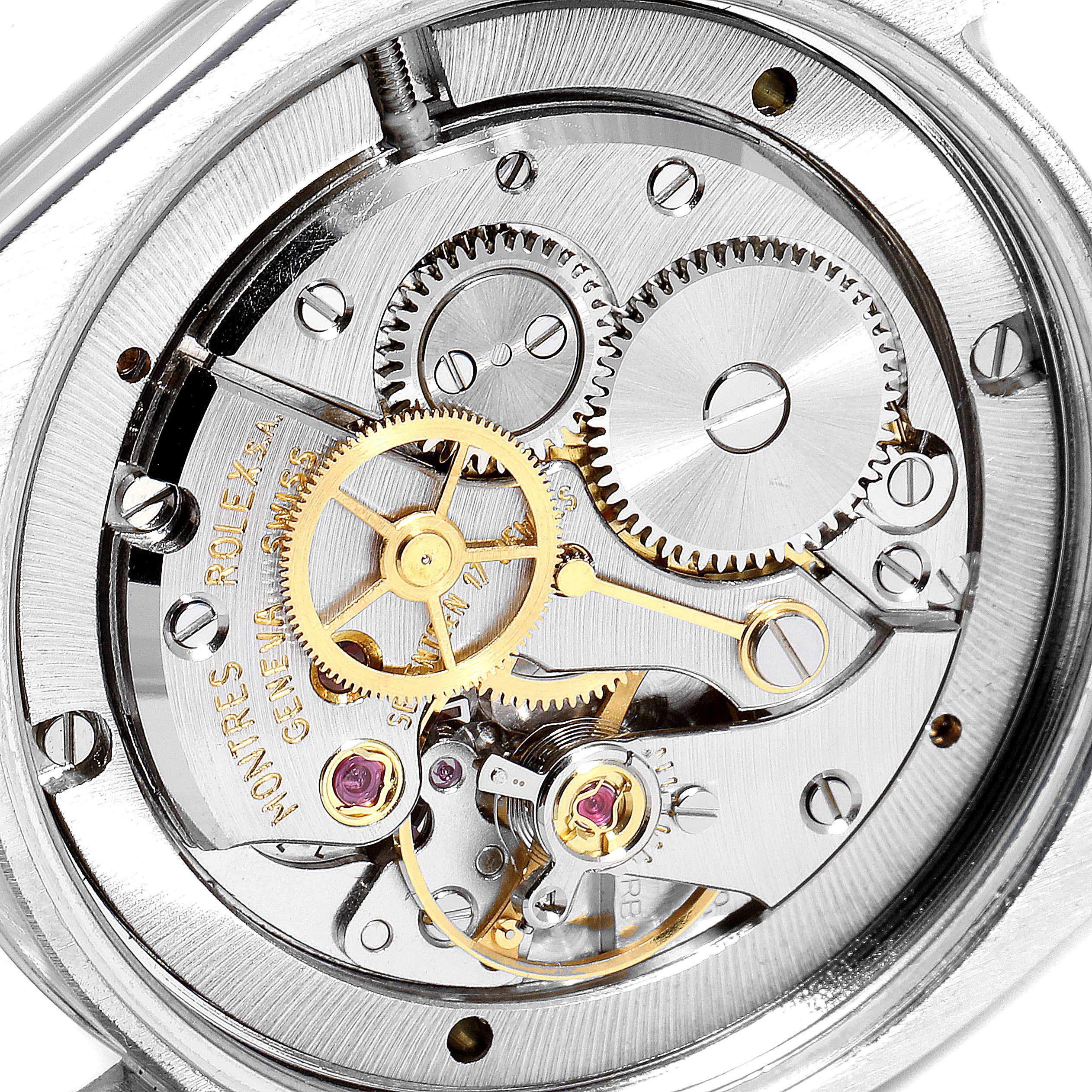 The image shows a close-up view of the internal mechanisms of a Rolex Vintage Collection 6694 Men's Stainless Steel Black Dial 6694 Men's Stainless Steel Black Dial watch, highlighting gears and intricate parts.