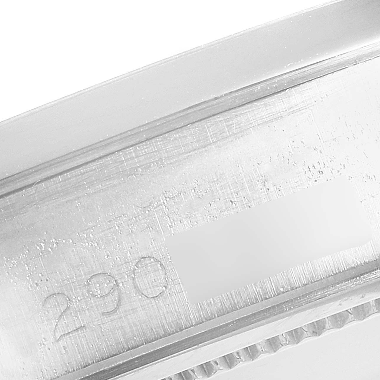 The image shows an angled close-up of the serial number on the casing of a Rolex Vintage Collection 6694 Men's Stainless Steel Black Dial 6694 Men's Stainless Steel Black Dial watch.