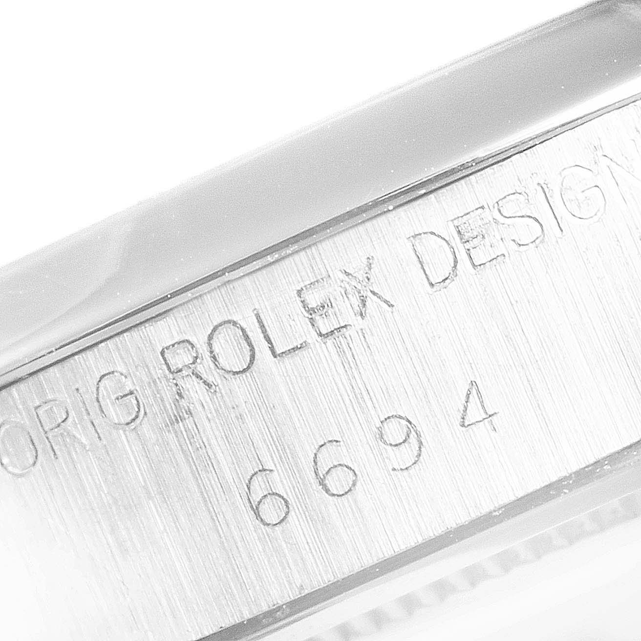 The image shows an engraved side view of a Vintage Collection model by Rolex, displaying the text "ORIG ROLEX DESIGN" and model number "6694."