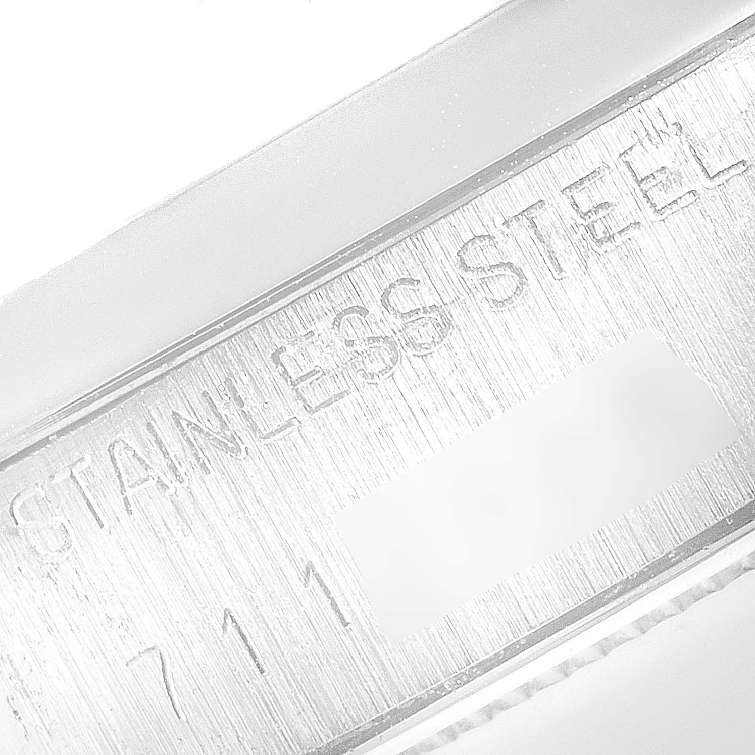 The image shows a close-up of the stainless steel part of the Vintage Collection model by Rolex, featuring engraved text.