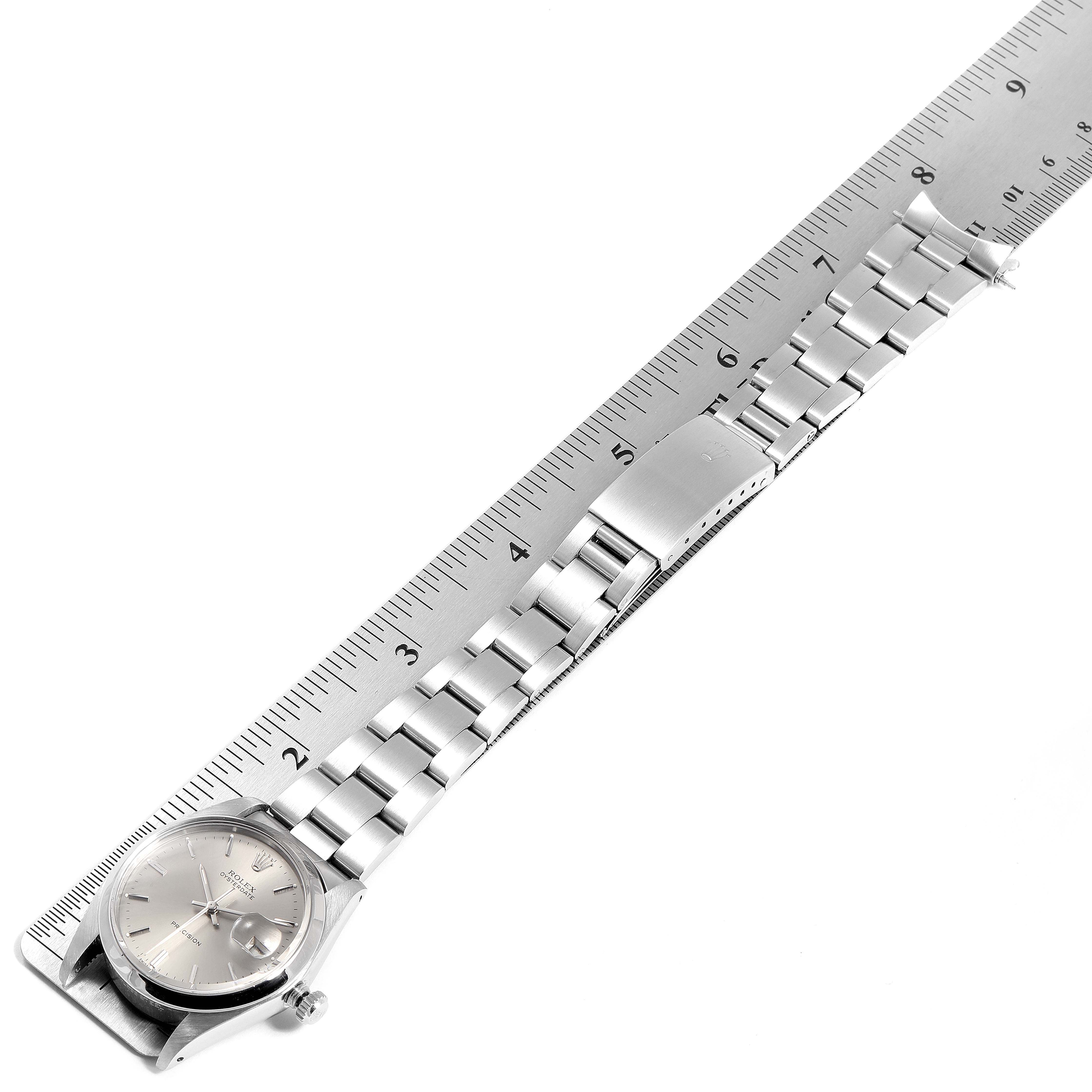 The image shows a Rolex Vintage Collection 6694 Men's Stainless Steel Silver Dial 6694 Men's Stainless Steel Silver Dial watch and its stainless steel band measured against a ruler.