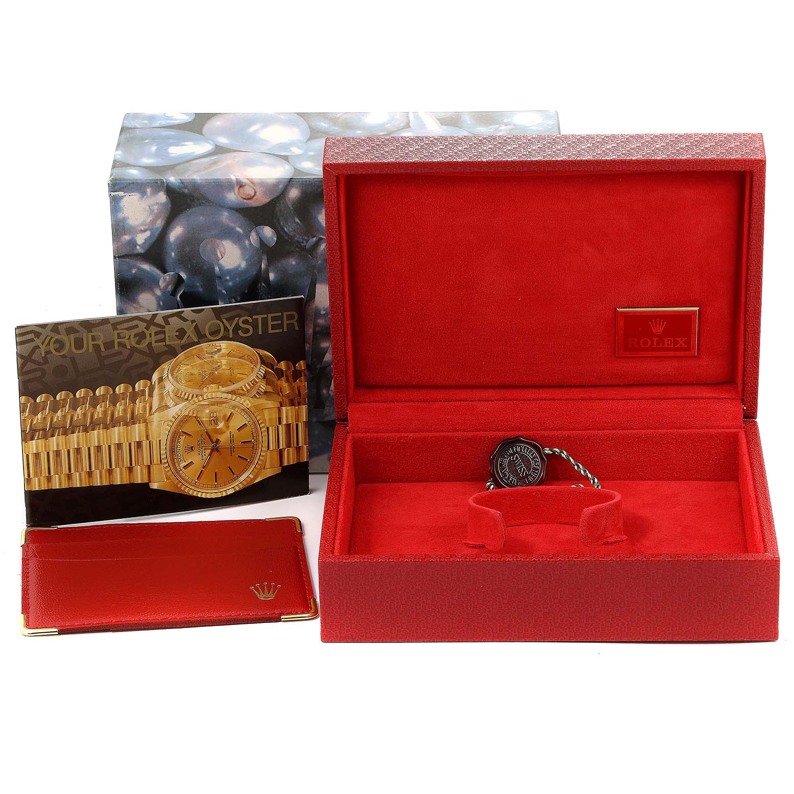 The image displays the accessories for a Rolex President 79088 Women
s Yellow Gold Silver Dial 79088 Women
s Yellow Gold Silver Dial model, including the box, booklet, and warranty card holder.