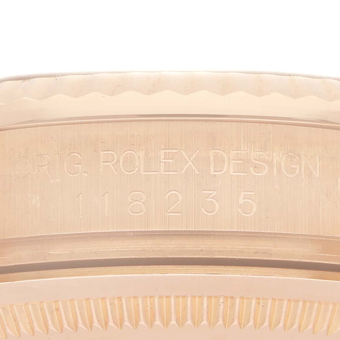 The image shows the side view of the Rolex Date 118235 Men
s Rose Gold Silver Dial model, highlighting the engraved serial number and design details on the case side.