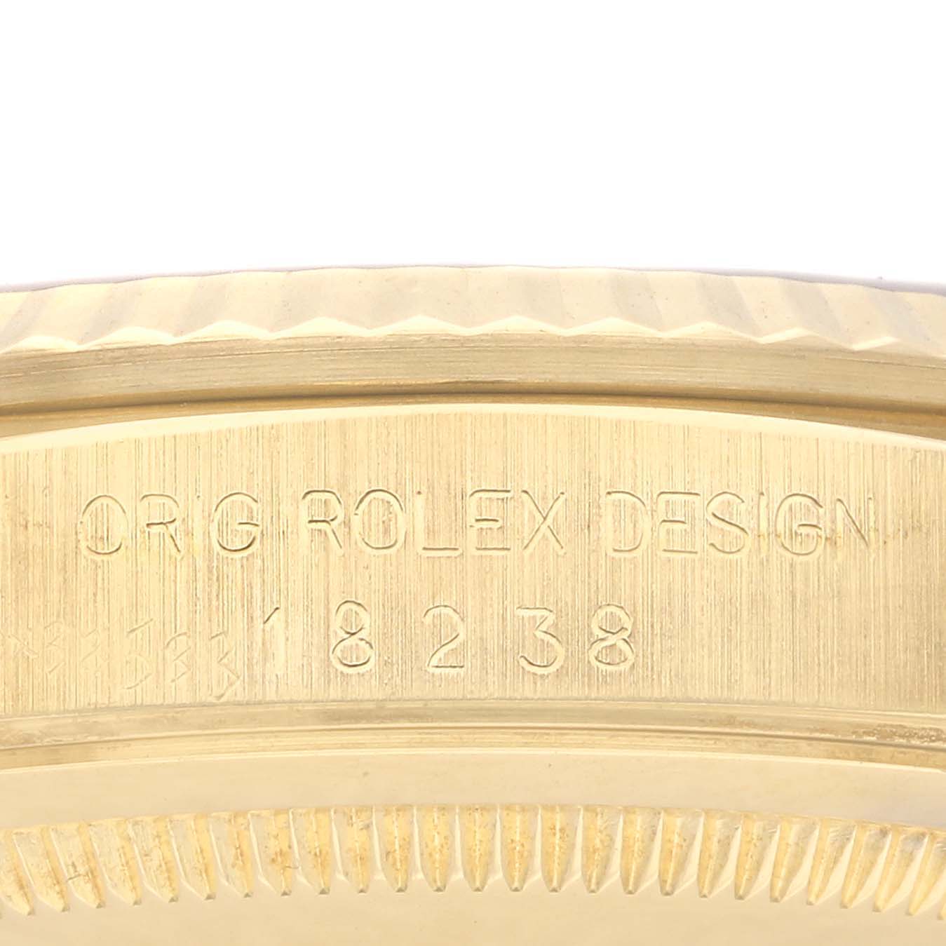 This image shows a close-up angle of the case detailing and serial number inscription of a Rolex President 18238 Men's Yellow Gold White Dial 18238 Men's Yellow Gold White Dial model.