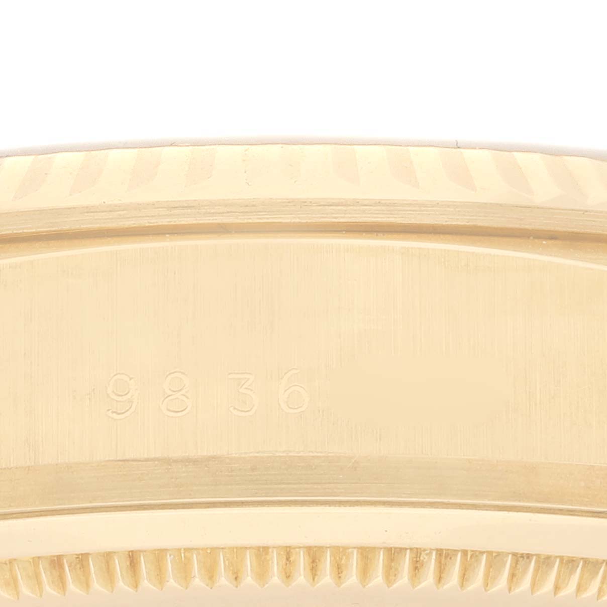 This image shows a close-up of the side of the gold bezel and case, including the serial number, on a Rolex President 18038 Men's Yellow Gold Champagne Dial 18038 Men's Yellow Gold Champagne Dial model watch.