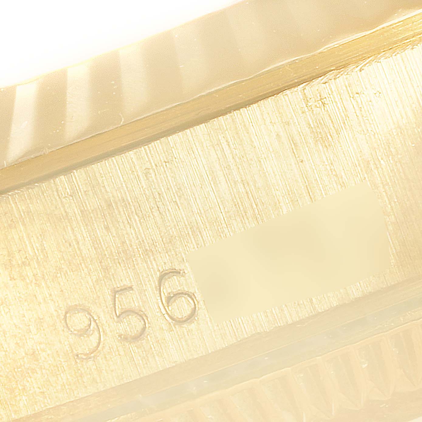 This close-up image shows the serial number area and the fluted bezel of a Rolex President 67198 Women
s Yellow Gold Champagne Dial 67198 Women
s Yellow Gold Champagne Dial watch.