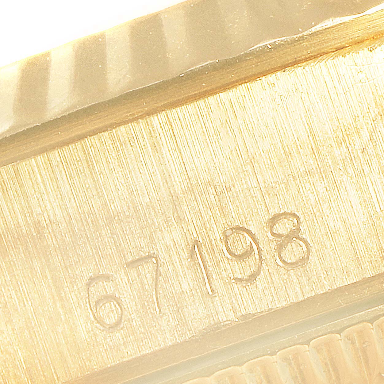 This close-up image shows the model number engraved on the side of a Rolex President 67198 Women
s Yellow Gold Champagne Dial 67198 Women
s Yellow Gold Champagne Dial watch.