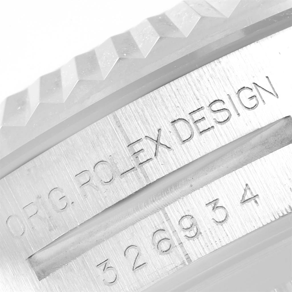 This close-up image of the Rolex Sky-Dweller 326934 Men's Stainless Steel Blue Dial 326934 Men's Stainless Steel Blue Dial watch shows part of the bezel and engraved text on the case side.