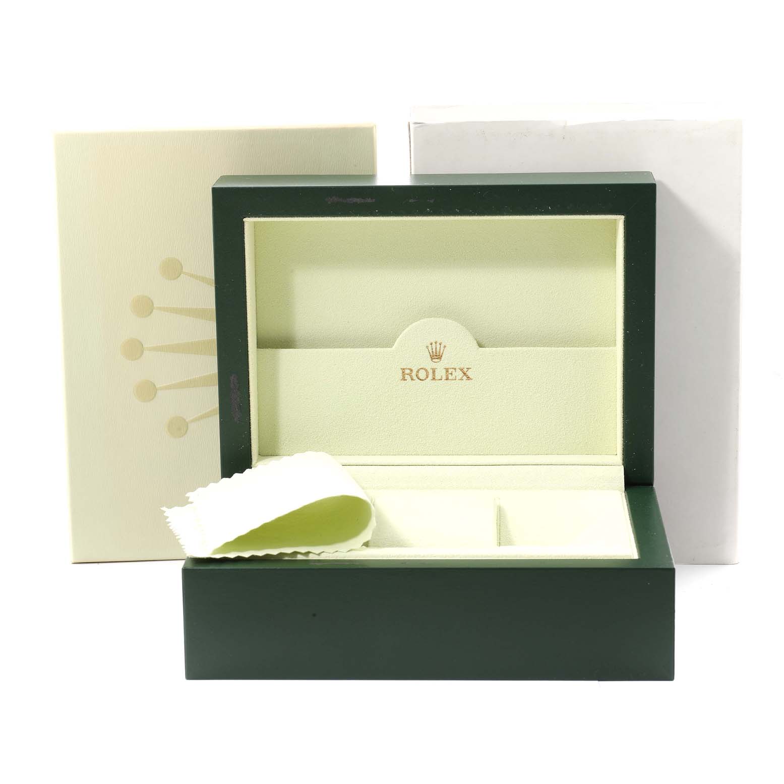 This image shows the open box and packaging for a Submariner model by Rolex, along with a cleaning cloth.