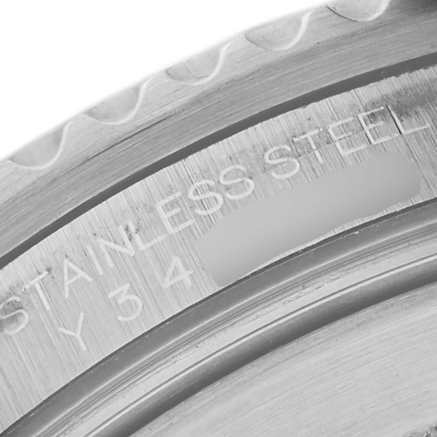 This close-up image shows the engraved inner bezel or case back of a Rolex Submariner 16610 Men
s Stainless Steel Black Dial 16610 Men
s Stainless Steel Black Dial watch, indicating it
s made of stainless steel.