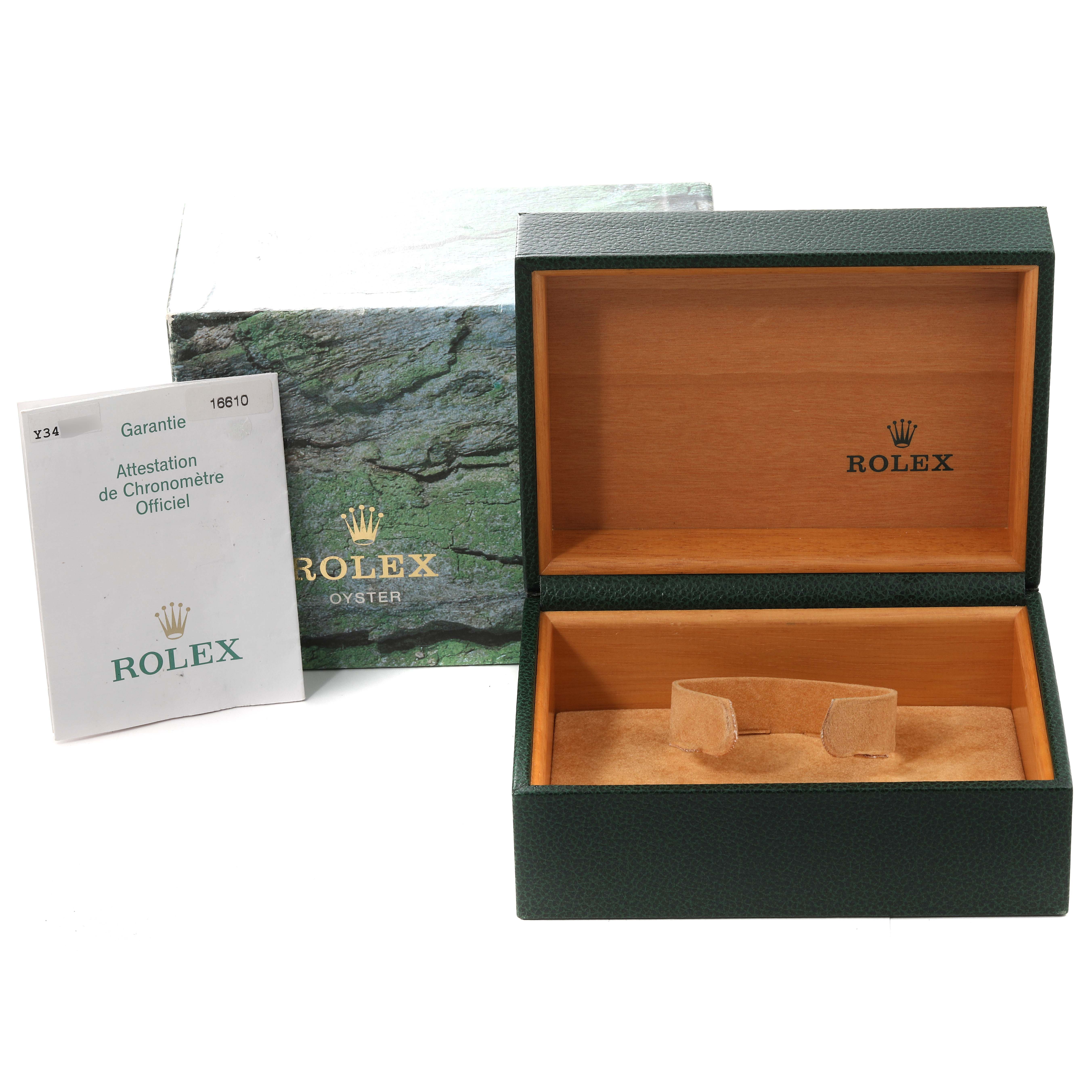 The image shows an open Rolex Submariner 16610 Men
s Stainless Steel Black Dial 16610 Men
s Stainless Steel Black Dial watch box, a warranty booklet, and an outer green box with branding.