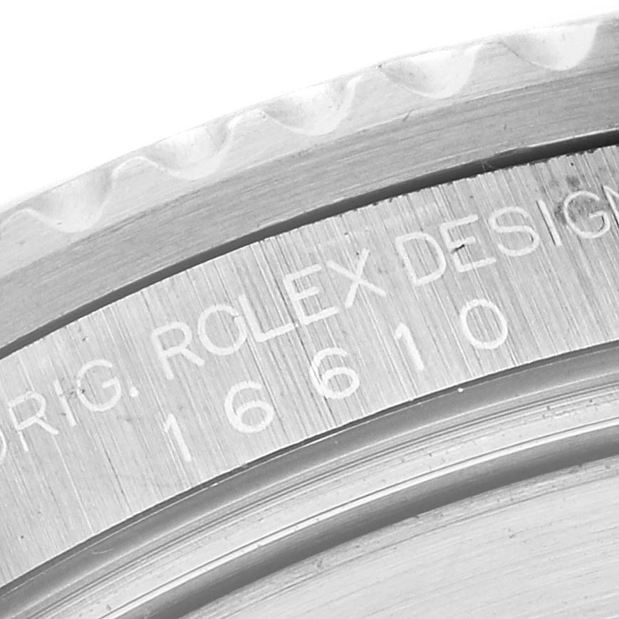 The image shows a close-up of the engraving on the inner bezel of a Rolex Submariner 16610 Men
s Stainless Steel Black Dial 16610 Men
s Stainless Steel Black Dial watch.