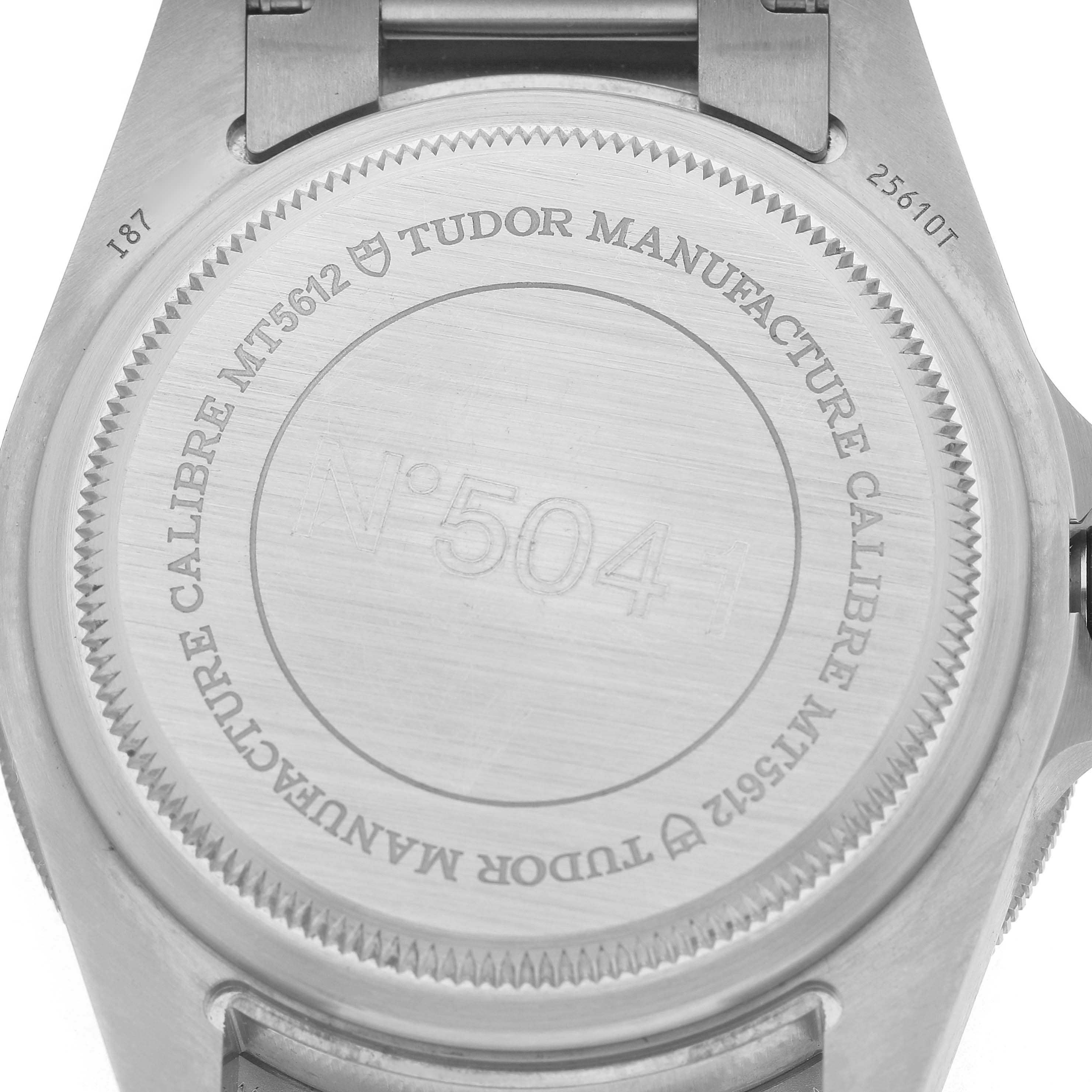 The image shows the back case of the Tudor Pelagos M25610TNL-0001 Men's Titanium Black Dial watch, featuring its model and caliber engravings.