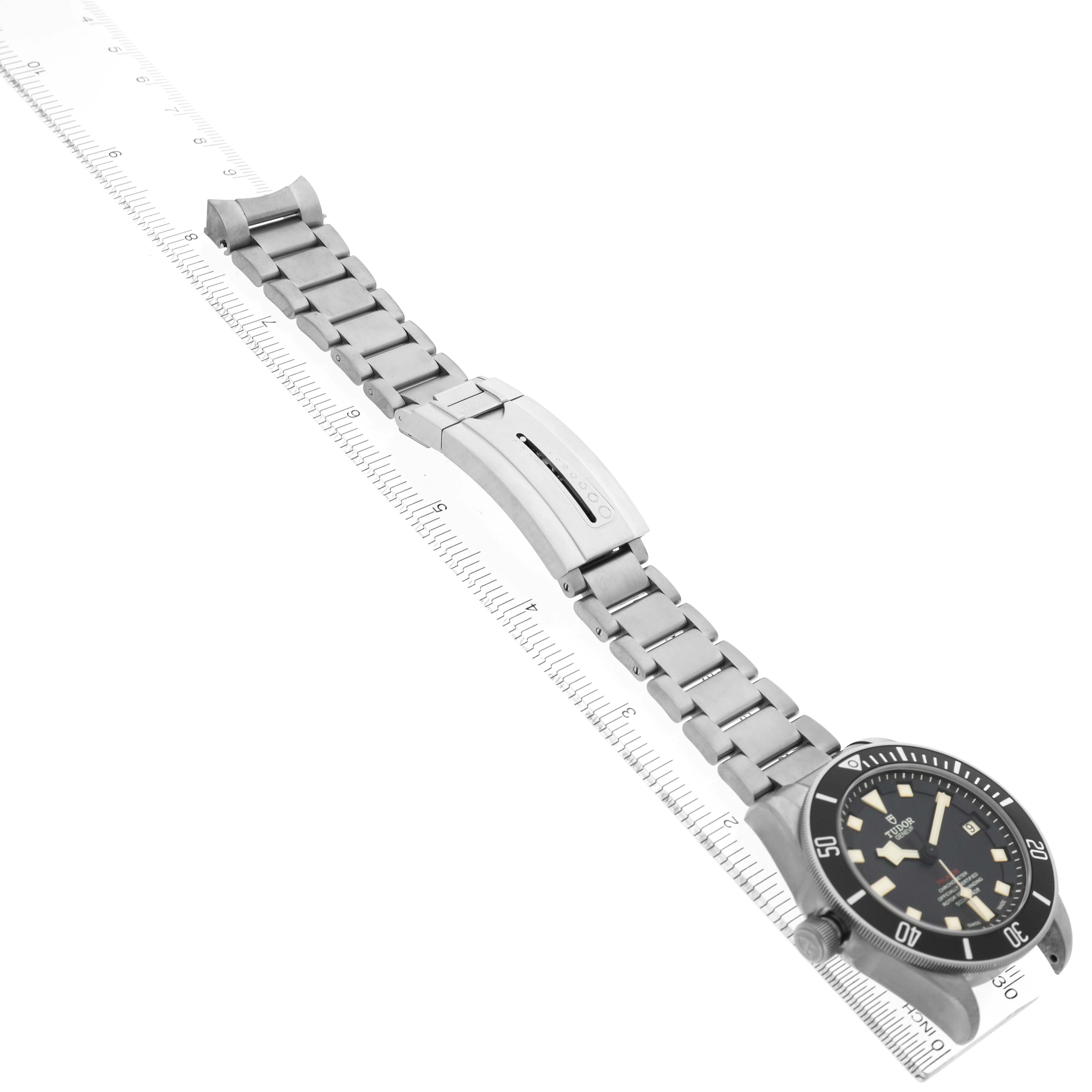 The Tudor Pelagos M25610TNL-0001 Men's Titanium Black Dial watch is shown from a diagonal side angle, displaying the bracelet, clasp, and dial.