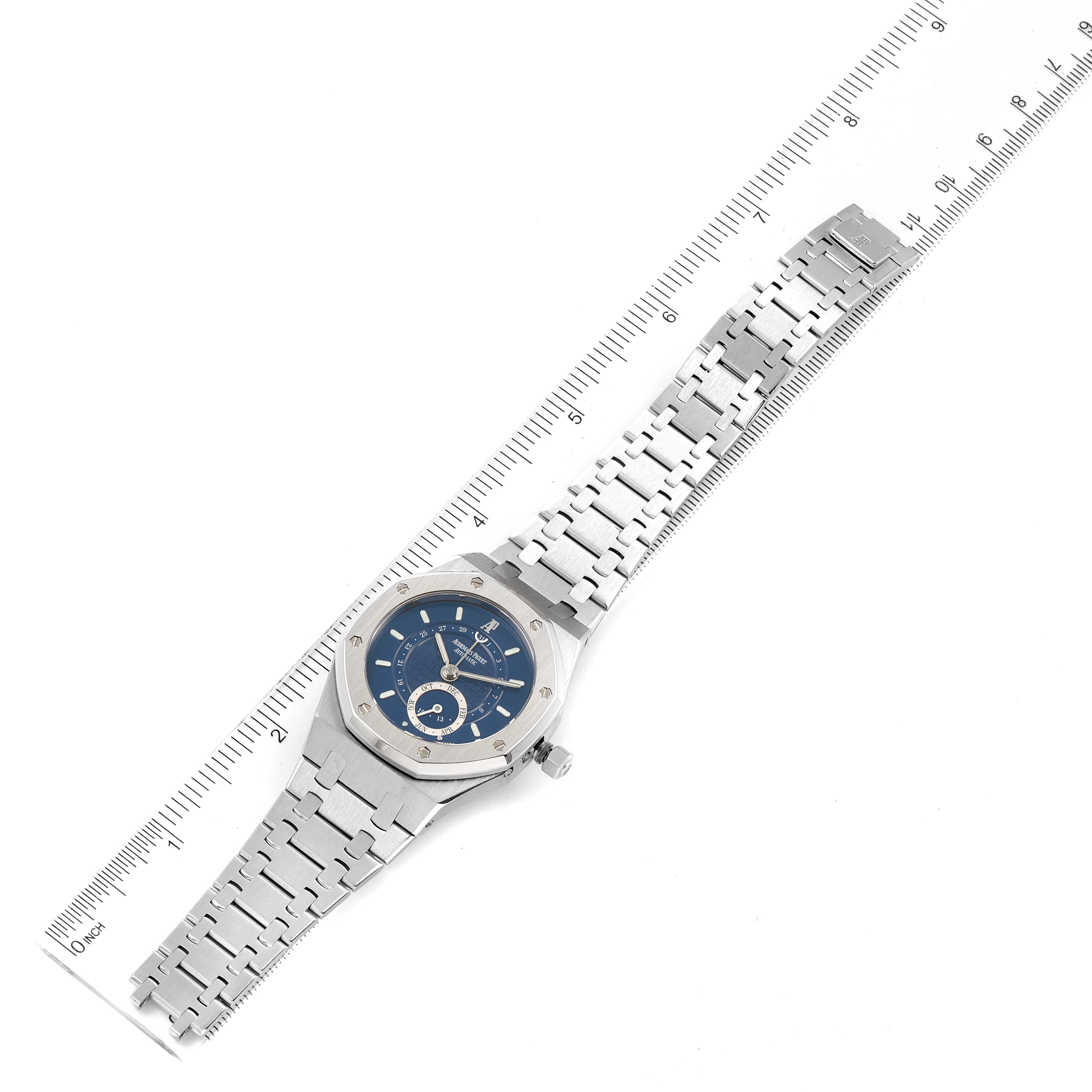 The image shows a top-down view of an Audemars Piguet Royal Oak 25920ST.0.0789ST.02 Men's Stainless Steel Blue Dial 25920ST.0.0789ST.02 Men's Stainless Steel Blue Dial watch with its entire bracelet and a measuring ruler alongside it.