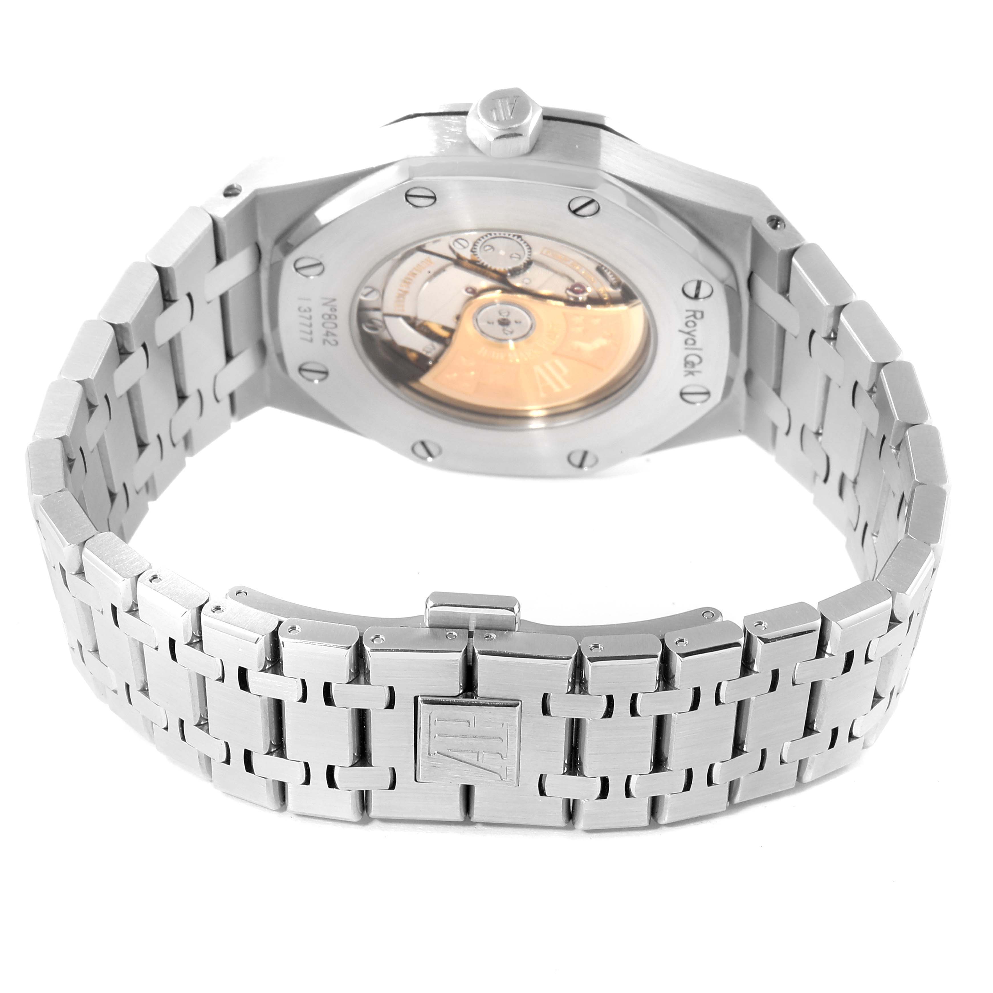 The image shows the back view of a Royal Oak watch by Audemars Piguet, highlighting the case back, bracelet, and part of the movement.