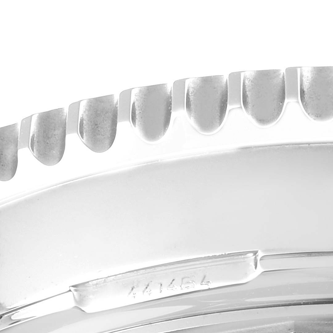 The image shows a close-up of the bezel edge and part of the caseback of a Breitling Navitimer AB044121/BD24/443A Men's Stainless Steel Black Dial AB044121/BD24/443A Men's Stainless Steel Black Dial watch.