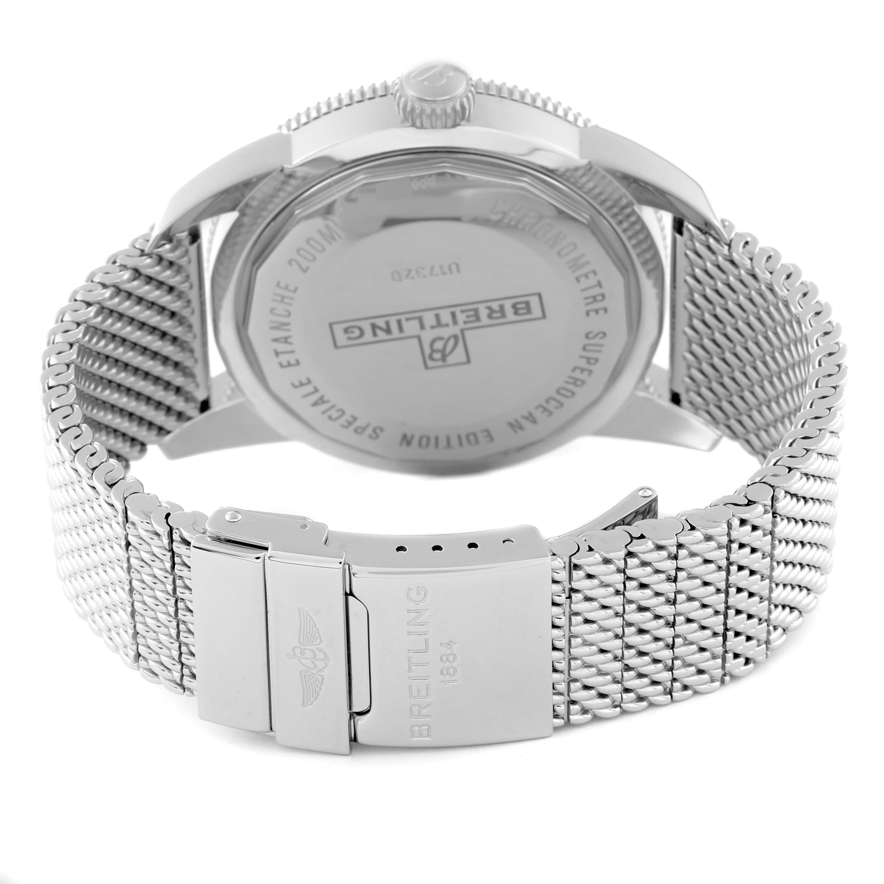 The image shows the back casing and clasp of a Breitling Superocean U17320 Men's Steel and Gold (two tone) Black Dial U17320 Men's Steel and Gold (two tone) Black Dial watch, featuring a mesh bracelet.