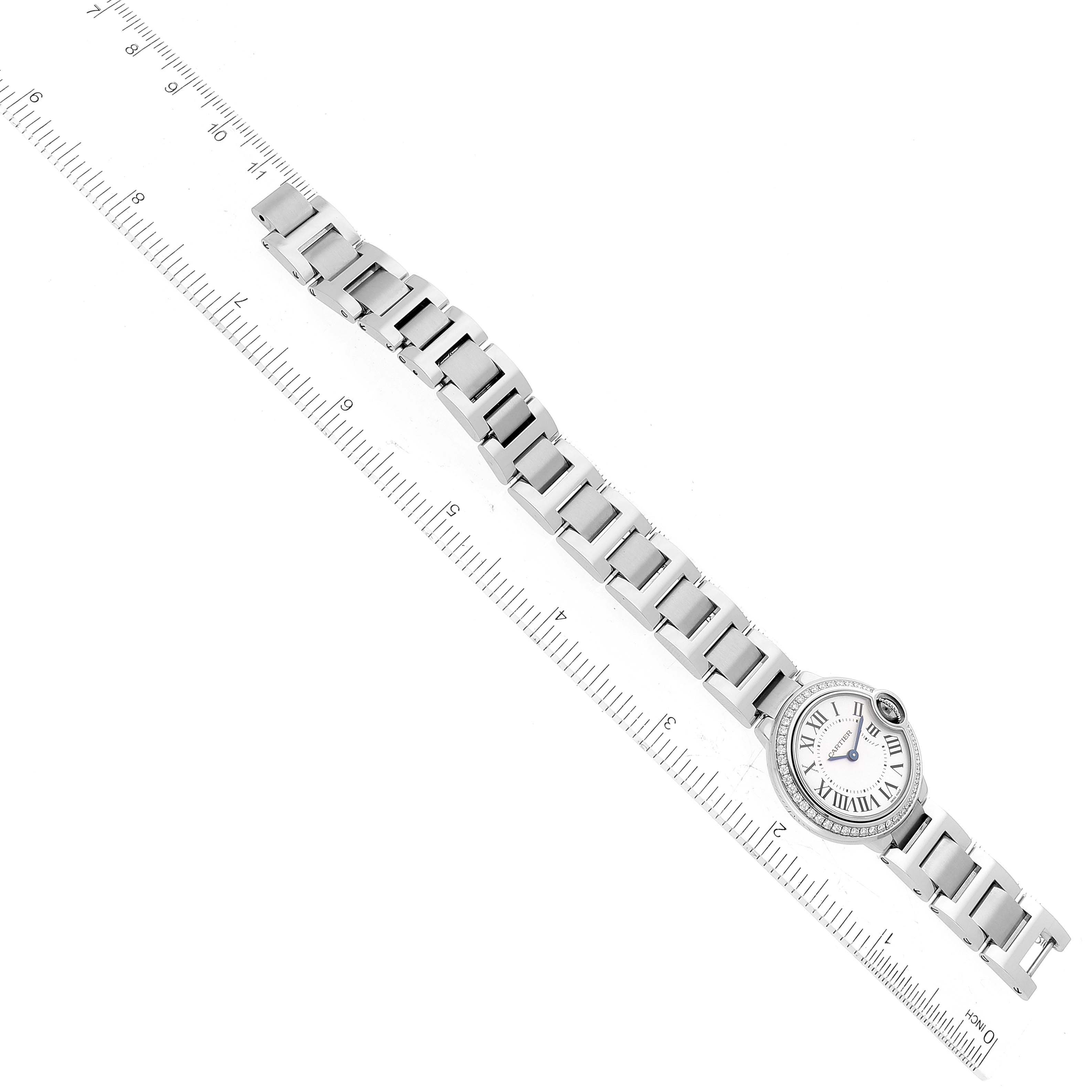 The image shows a top view of a Cartier Ballon Bleu W4BB0015 Women's Stainless Steel Silver Dial W4BB0015 Women's Stainless Steel Silver Dial watch placed alongside a ruler for scale, displaying its bracelet and face.