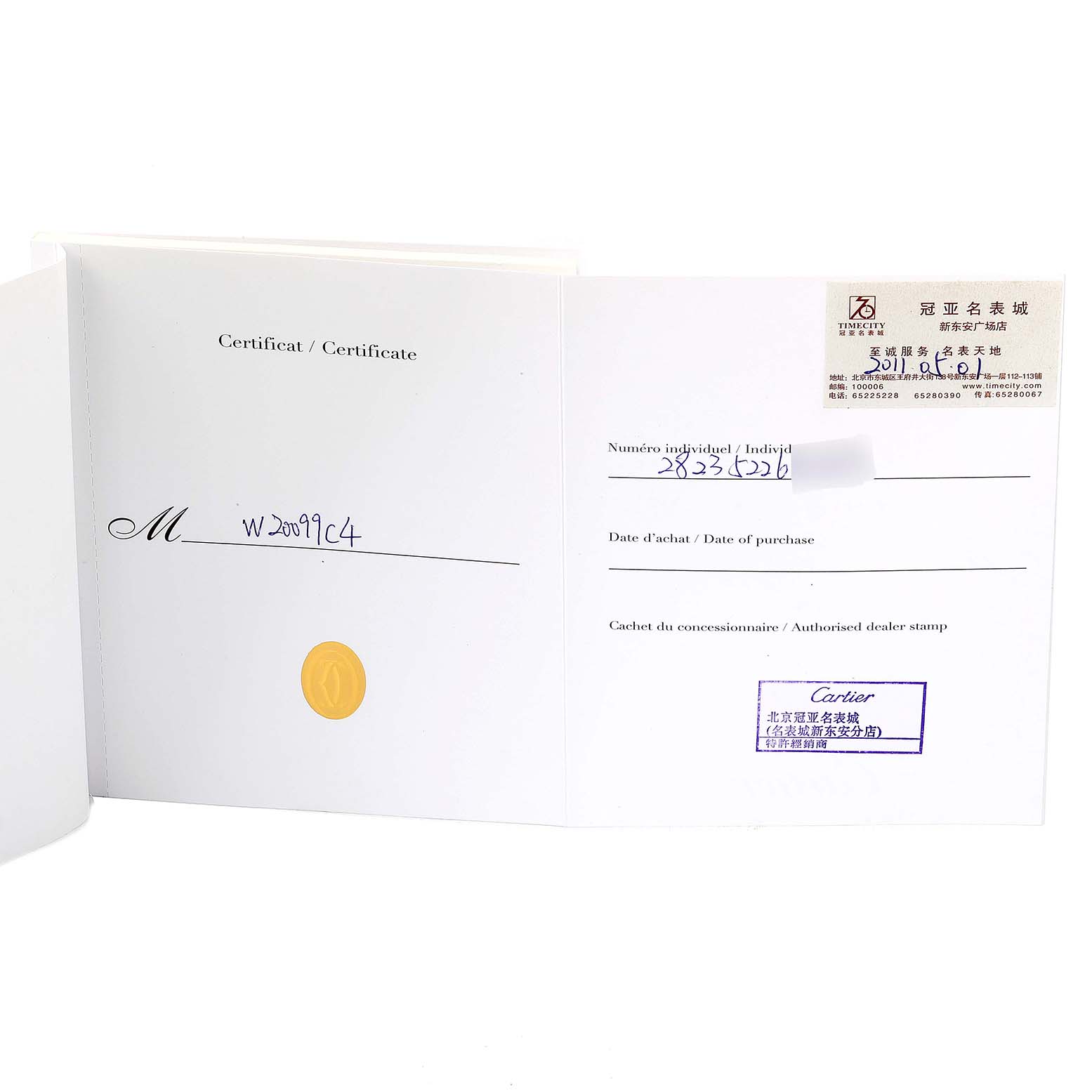 This image shows an open certificate of authenticity with dealer stamps for a Santos model by Cartier.