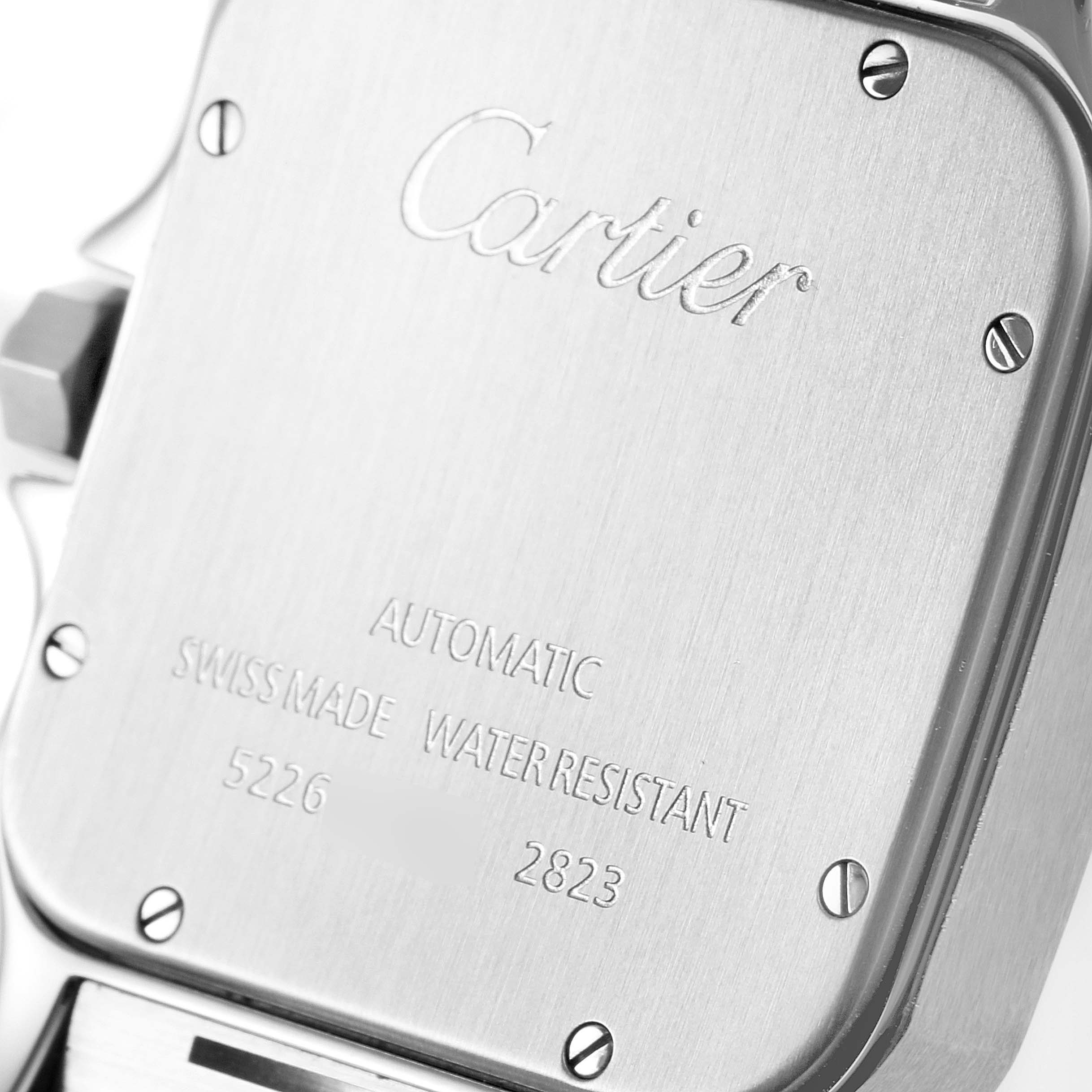This image shows the back case of the Cartier Santos W20099C4 Men's Steel and Gold (two tone) Silver Dial W20099C4 Men's Steel and Gold (two tone) Silver Dial automatic watch, highlighting the brand engraving and specifications.
