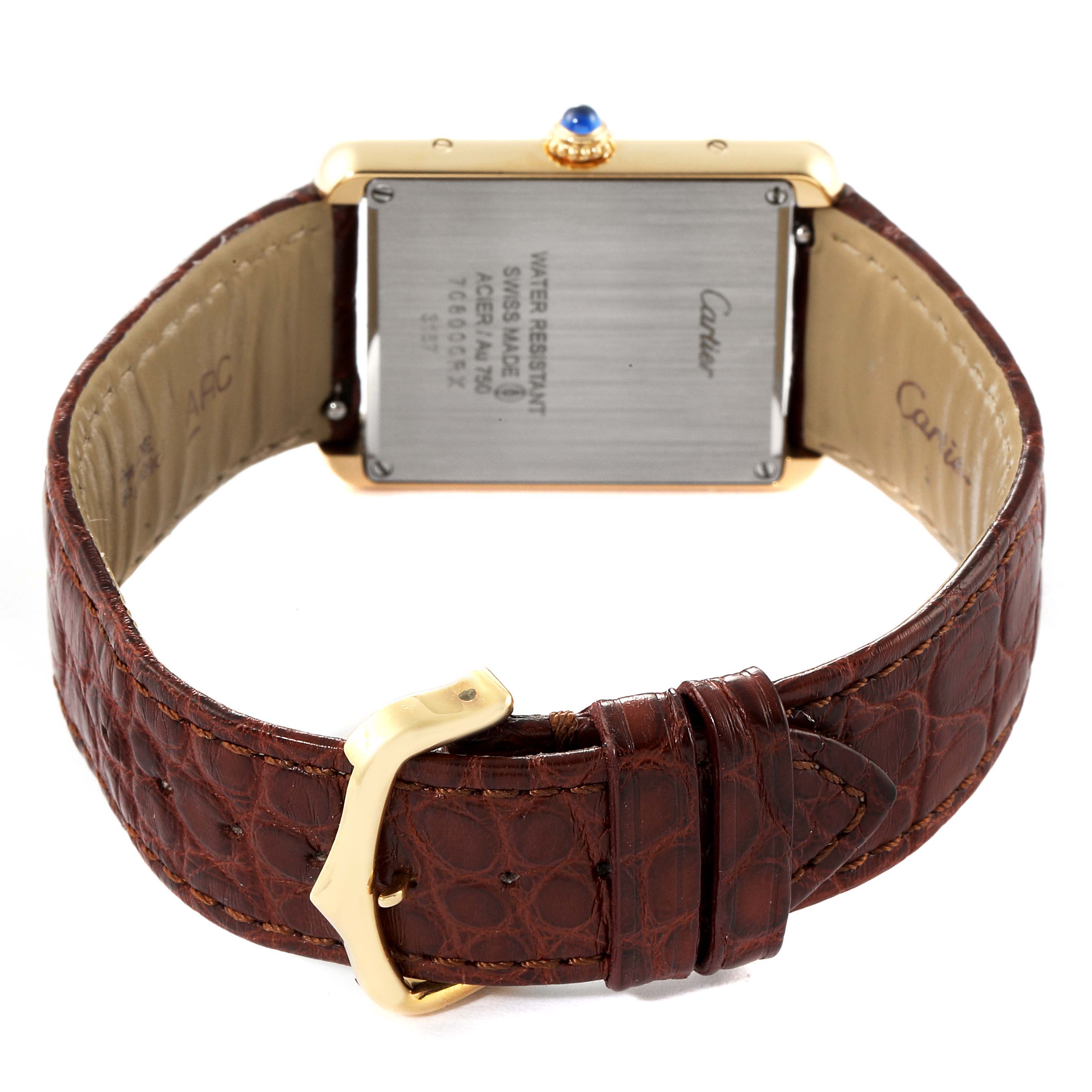 The image shows the back view of a Cartier Tank Solo W5200004 Men's Yellow Gold Silver Dial W5200004 Men's Yellow Gold Silver Dial watch with a brown leather strap and gold-tone buckle.