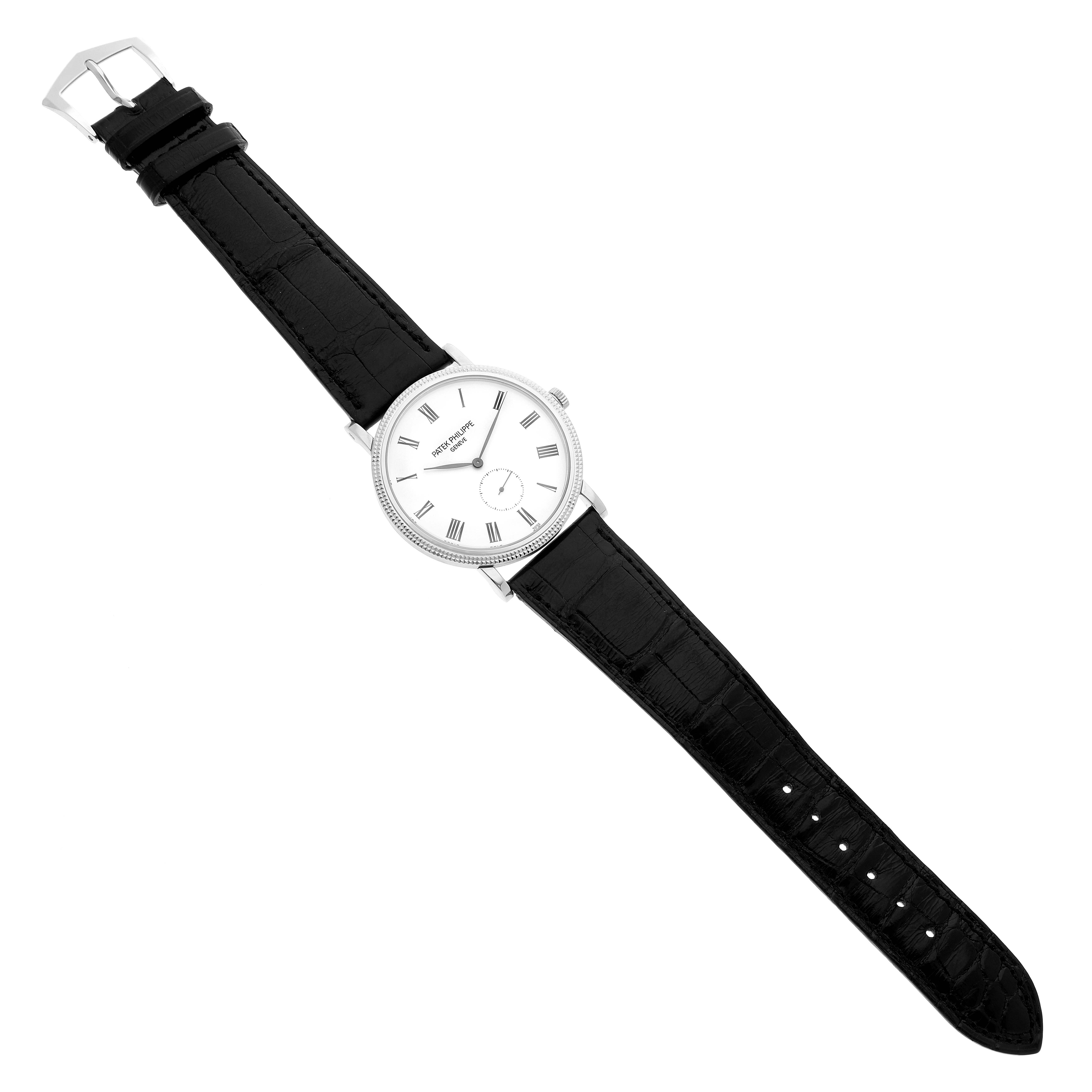 This image shows a top-down view of a Patek Philippe Calatrava 5119G Men's White Gold White Dial 5119G Men's White Gold White Dial watch, featuring its dial, black leather strap, and buckle.