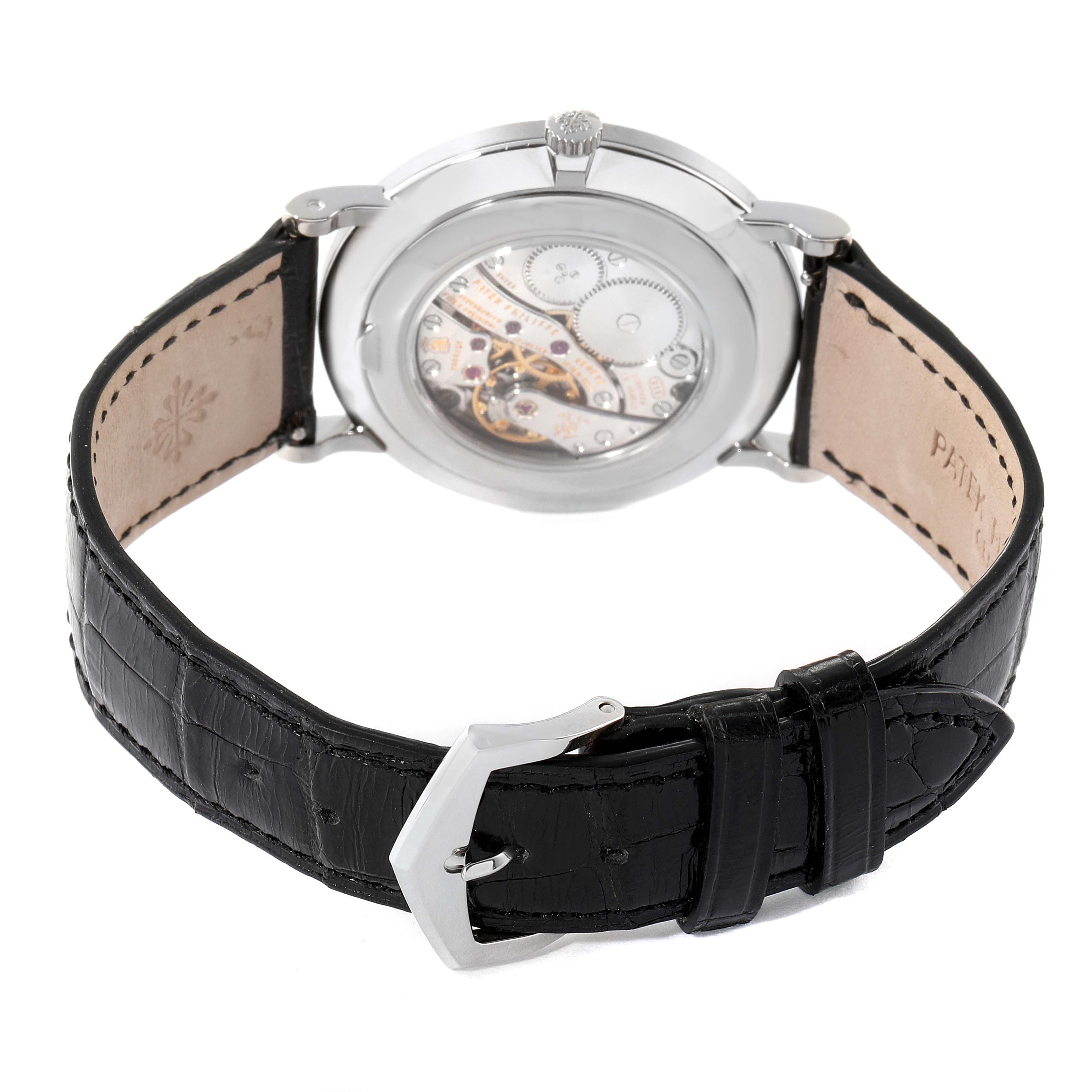 The image shows the back and strap of a Patek Philippe Calatrava 5119G Men's White Gold White Dial 5119G Men's White Gold White Dial watch, highlighting its mechanism and black leather strap.