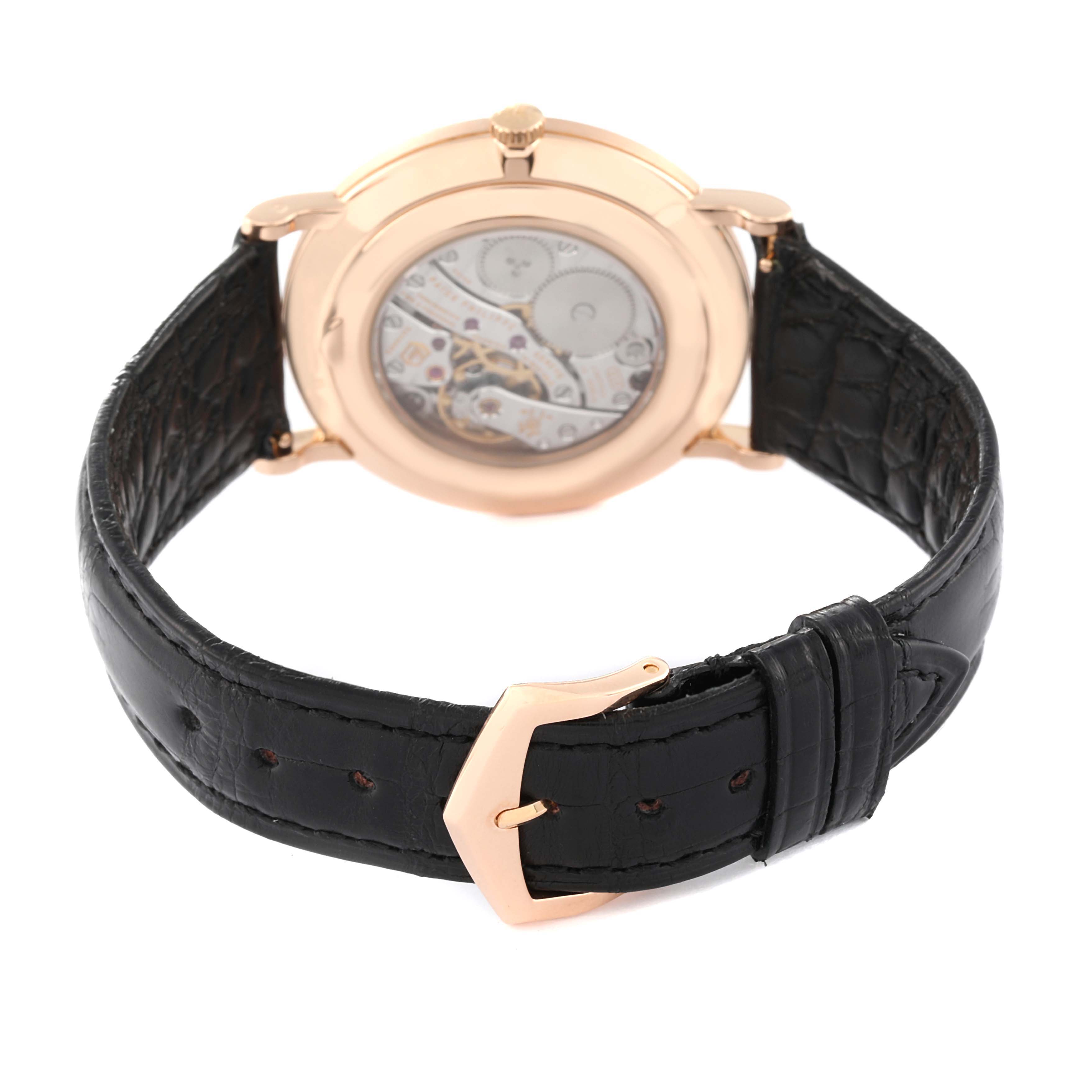 The image shows the back view of a Patek Philippe Calatrava 5119R Men's Rose Gold White Dial 5119R Men's Rose Gold White Dial watch with its transparent case back and black leather strap.
