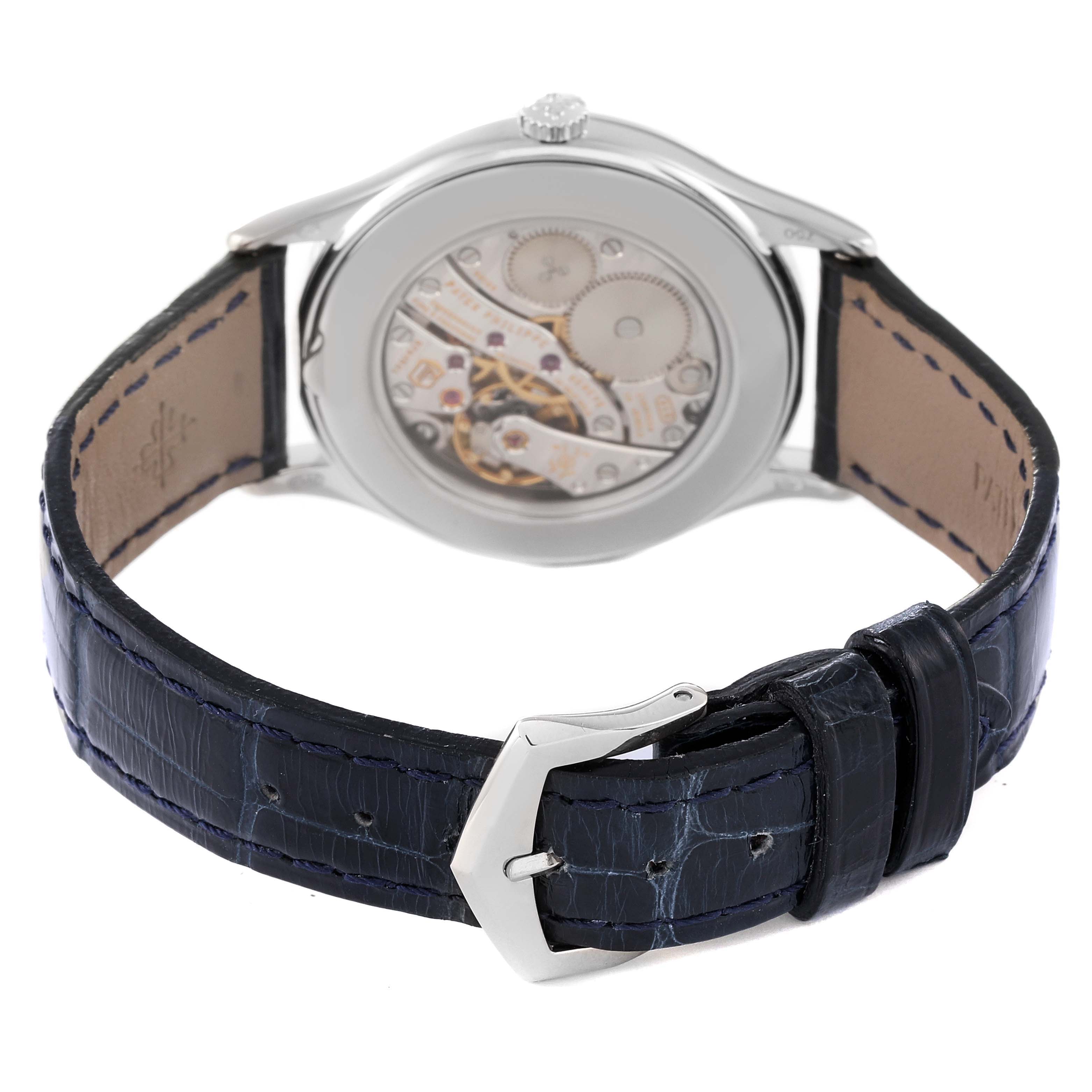 The image shows the back view of a Patek Philippe Calatrava 4897G-001 Women's White Gold Blue Dial 4897G-001 Women's White Gold Blue Dial model, highlighting the transparent caseback and dark leather strap.