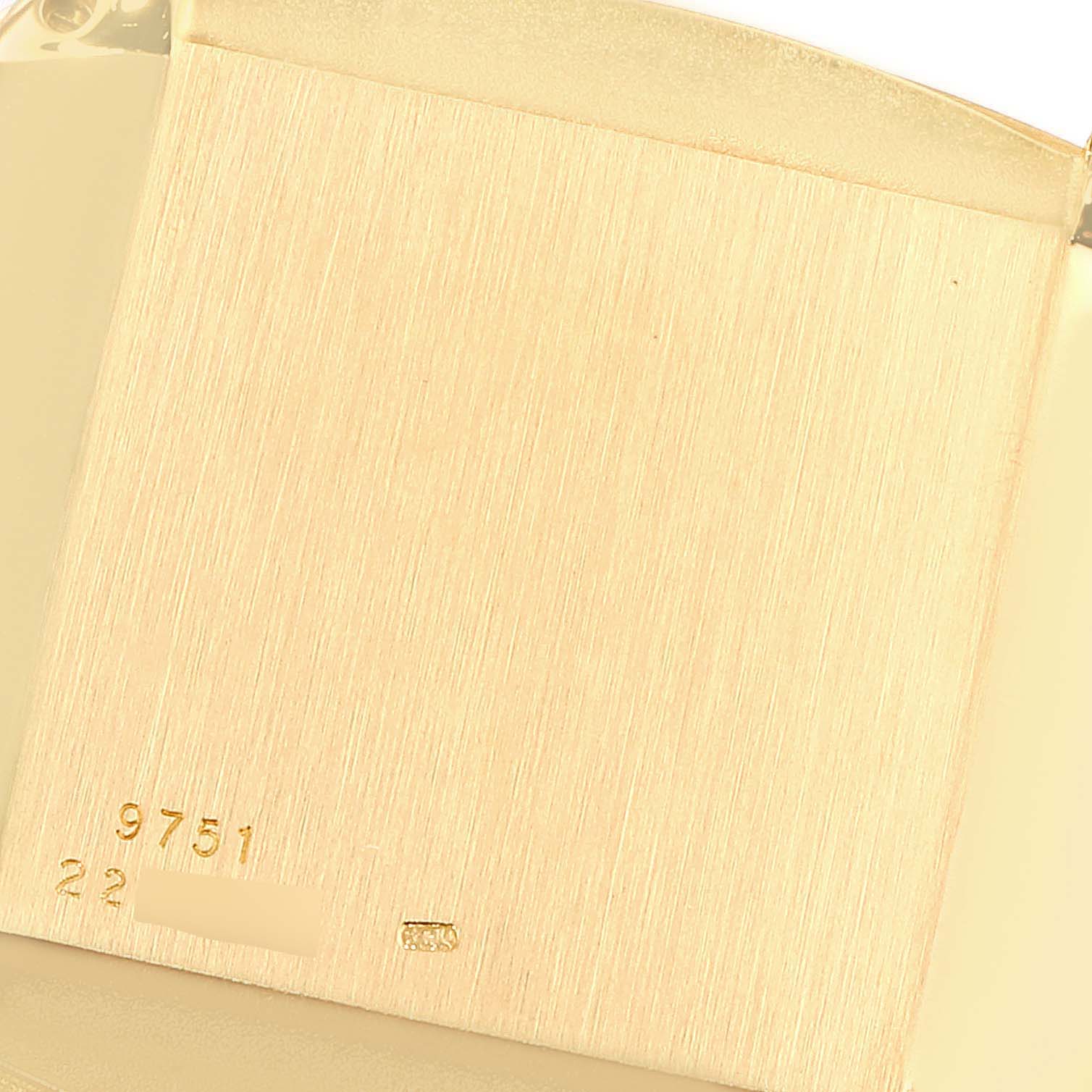 This image shows the back casing of the Piaget 9751 Men's Yellow Gold Black Dial 9751 Men's Yellow Gold Black Dial 9751 model, highlighting the engraved model number and hallmark details.