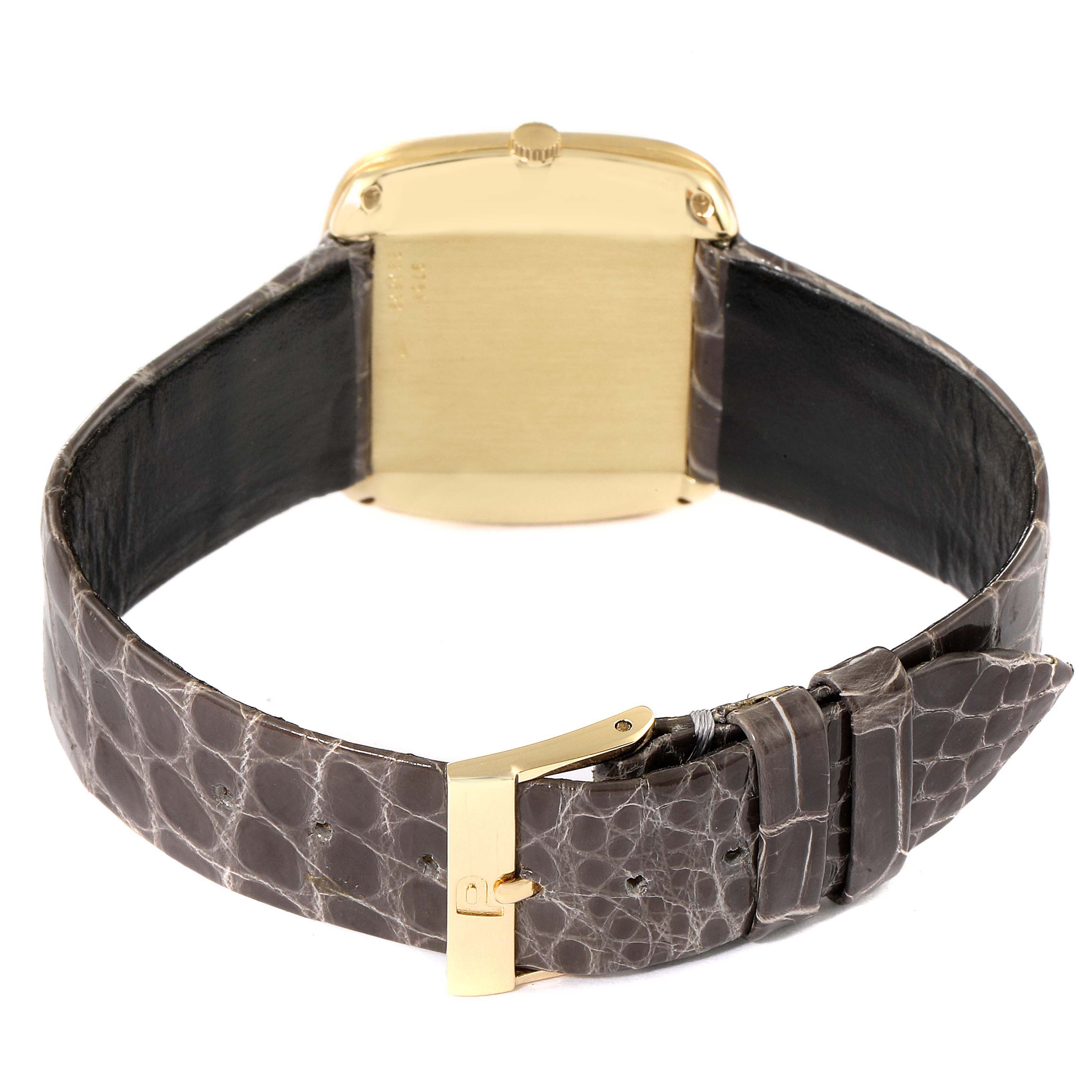 The image shows the back angle of the Piaget 9751 Men's Yellow Gold Black Dial 9751 Men's Yellow Gold Black Dial 9751 model, highlighting the gold case and grey strap with a gold buckle.