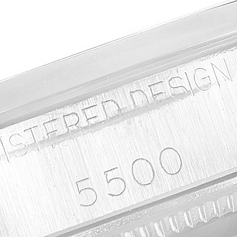 The image shows an extreme close-up of the serial number and "REGISTERED DESIGN" engraving on a Vintage Collection Rolex model 5500.