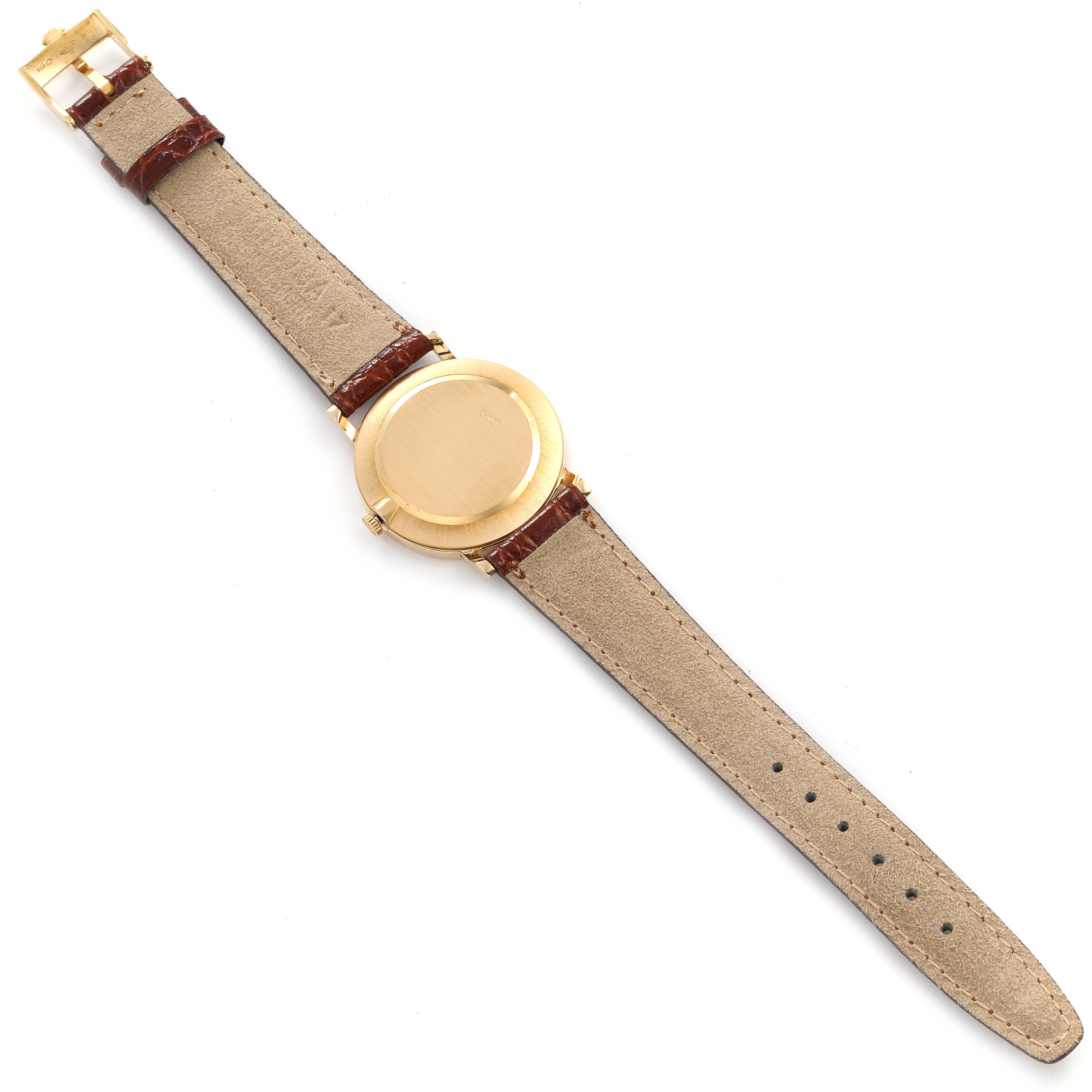 The image shows the back and leather straps of a Rolex Cellini 5112 Men's Yellow Gold Champagne Dial 5112 Men's Yellow Gold Champagne Dial watch laid flat.