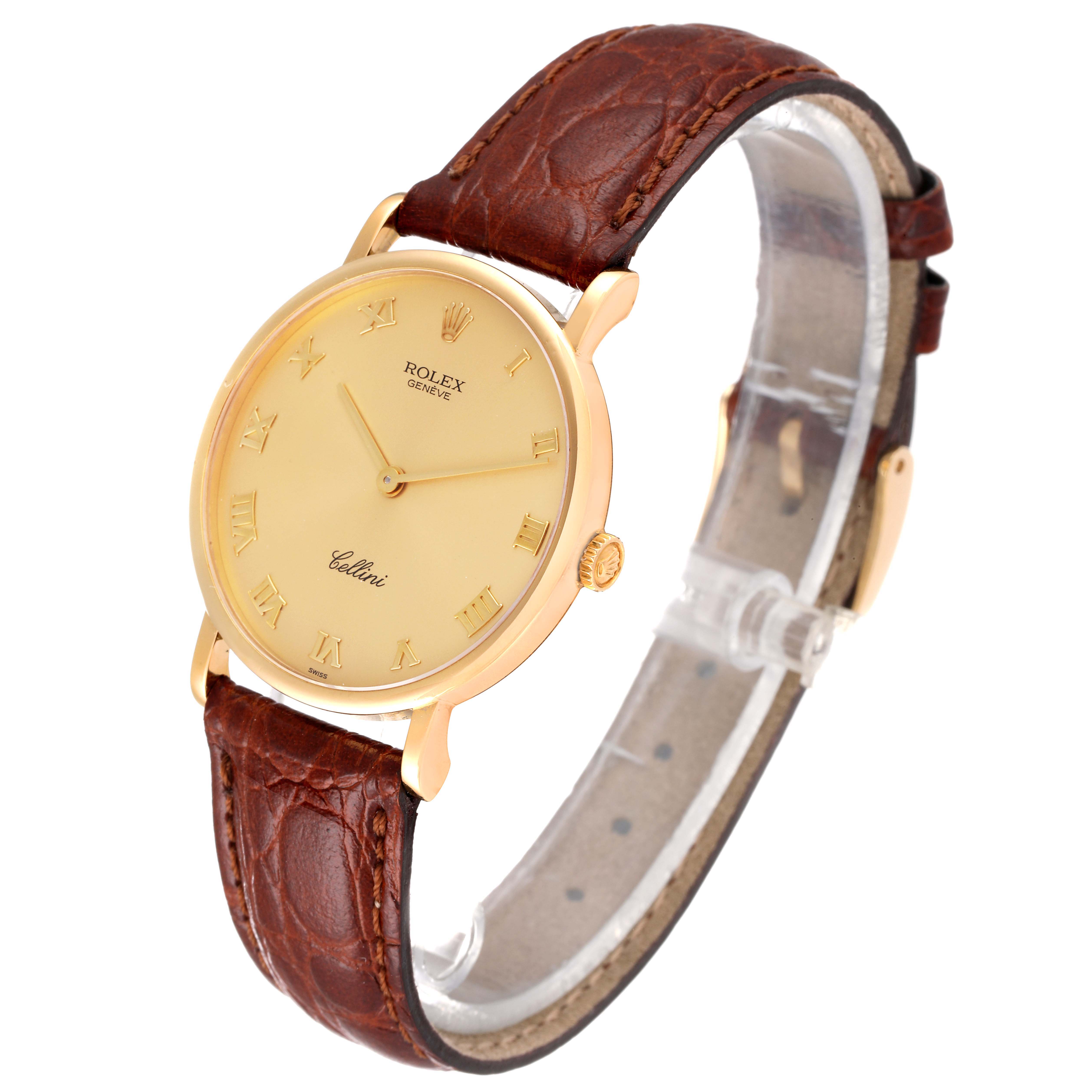 The Rolex Cellini 5112 Men's Yellow Gold Champagne Dial 5112 Men's Yellow Gold Champagne Dial watch is shown at a slight angle, displaying its gold case, brown leather strap, and gold dial with Roman numerals.