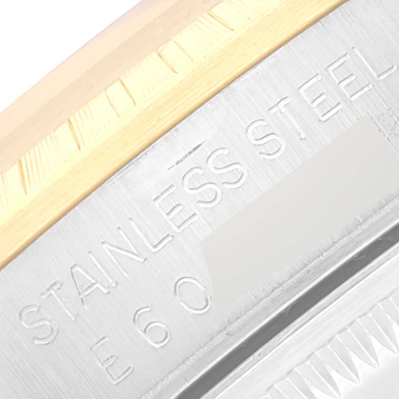 The image shows a close-up of the bezel and case back of the Rolex Date 15223 Men's Steel and Gold (two tone) White Dial 15223 Men's Steel and Gold (two tone) White Dial model, emphasizing the "STAINLESS STEEL" engraving.