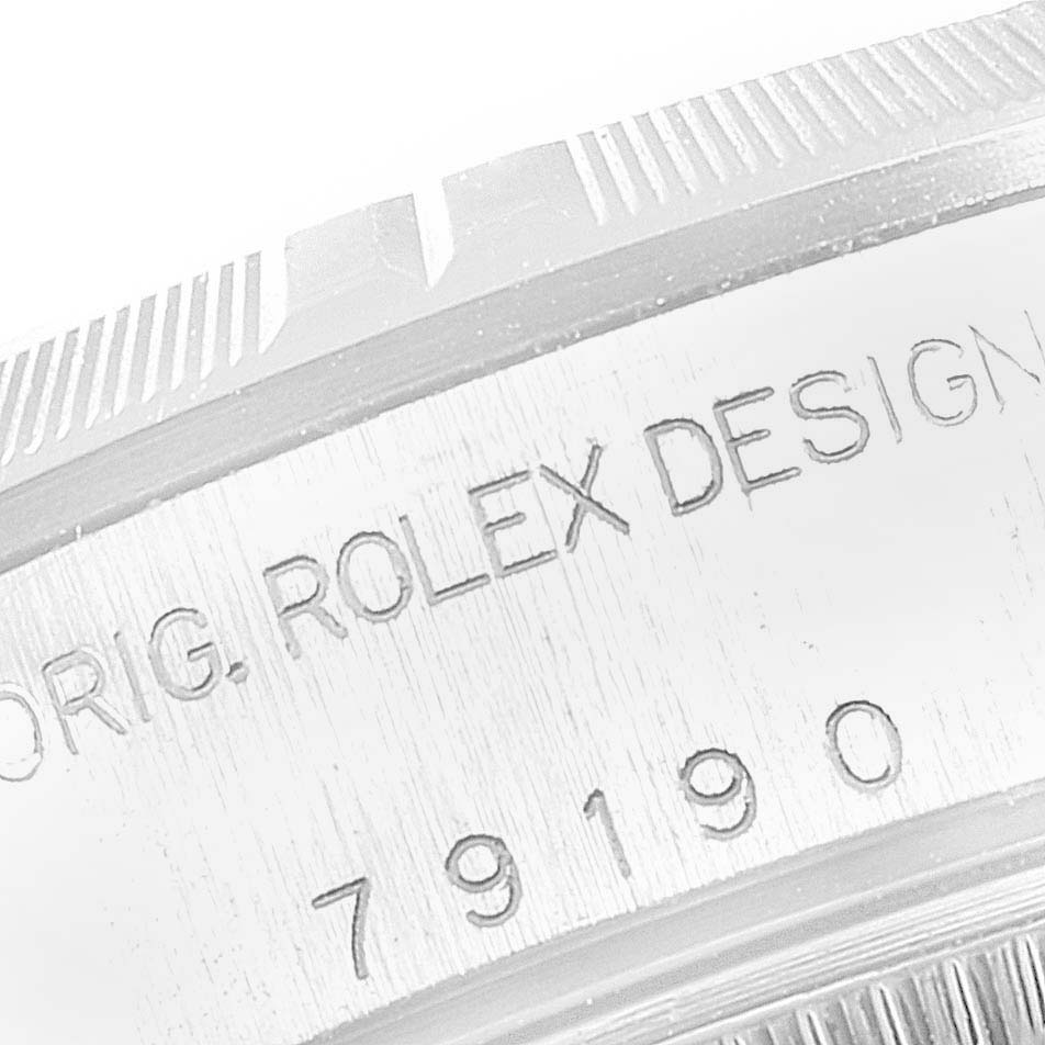 This image shows a close-up of the side of a Rolex Date 79190 Women's Stainless Steel White Dial 79190 Women's Stainless Steel White Dial model, displaying the inscription "ORIG. ROLEX DESIGN" and the model number.
