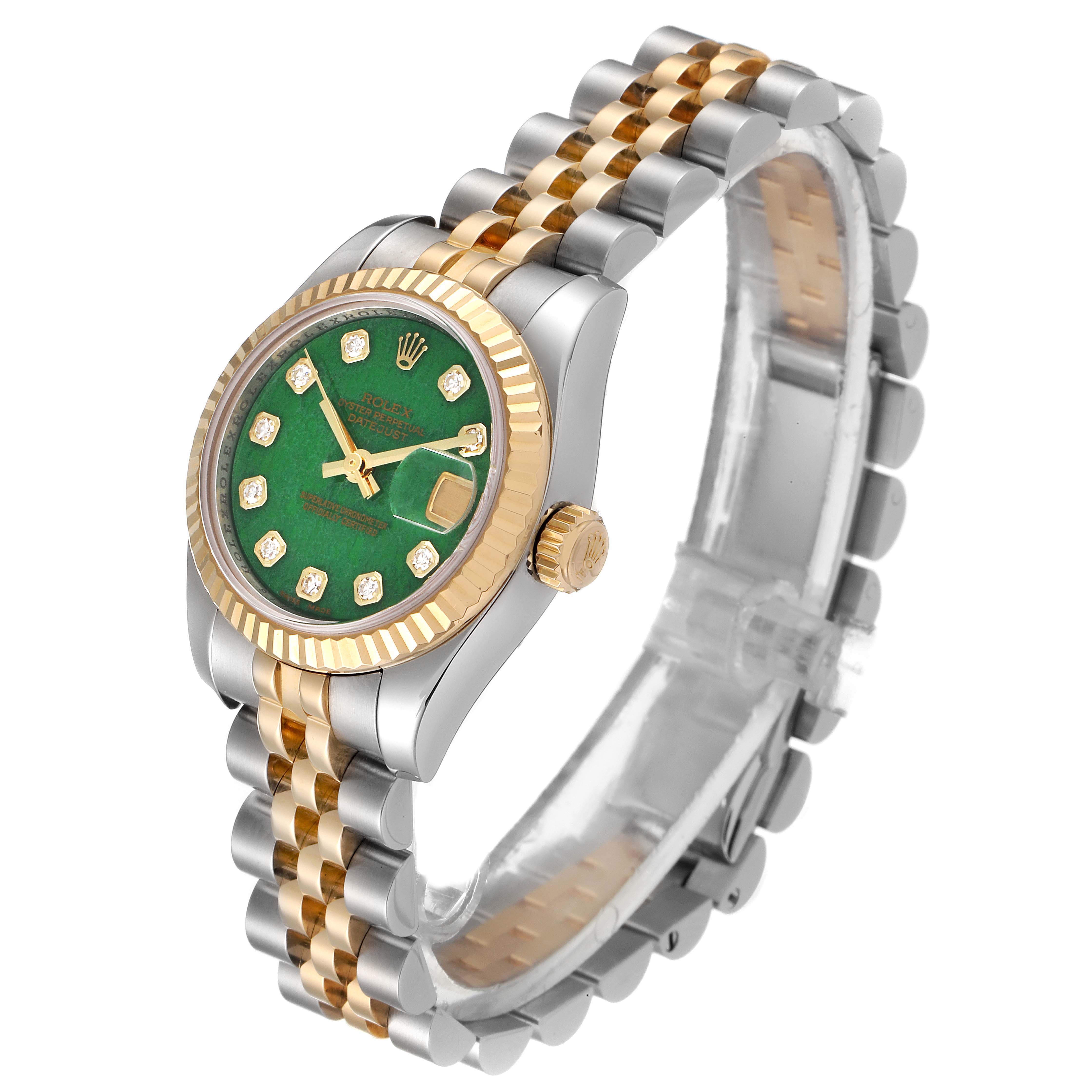This image shows a Rolex Datejust 179173 Women's Steel and Gold (two tone) Green Dial 179173 Women's Steel and Gold (two tone) Green Dial watch at an angled side view, featuring a green dial, gold fluted bezel, and two-tone bracelet.