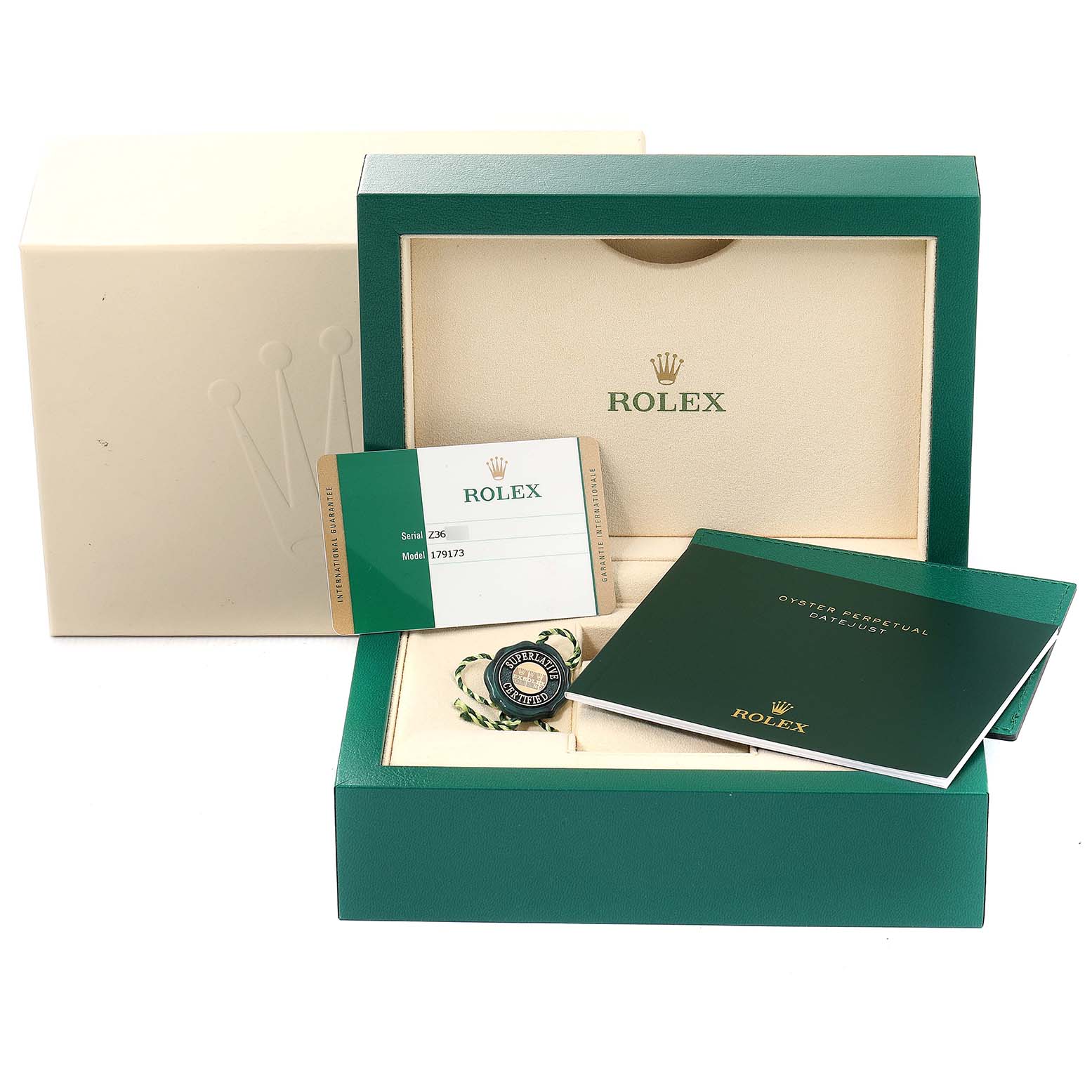 The image shows packaging and accessories for a Rolex Datejust 179173 Women's Steel and Gold (two tone) Green Dial 179173 Women's Steel and Gold (two tone) Green Dial, including the box, warranty card, and manuals.
