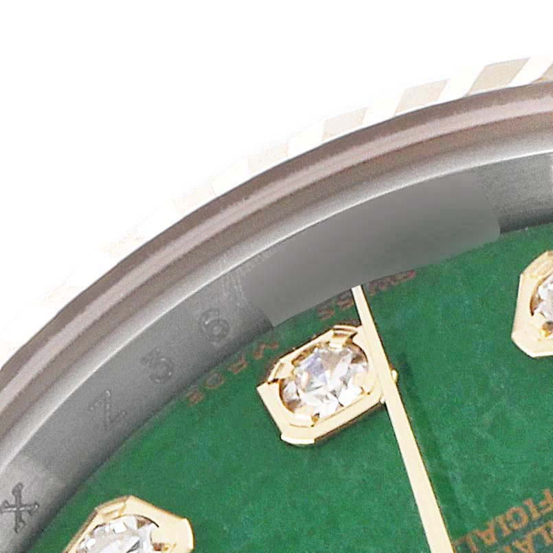This image shows a close-up of the dial, hands, and diamond hour markers of a Rolex Datejust 179173 Women's Steel and Gold (two tone) Green Dial 179173 Women's Steel and Gold (two tone) Green Dial watch.