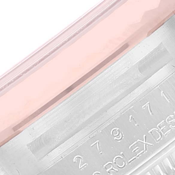 This image shows a close-up view of the Rolex Datejust 279171 Women's Steel and Gold (two tone) Pink Dial 279171 Women's Steel and Gold (two tone) Pink Dial watch's bezel and part of the engraved serial number.