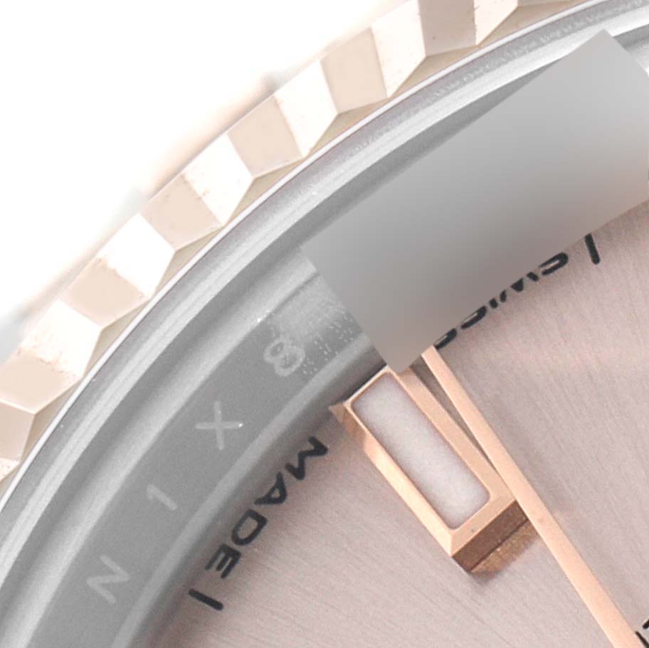 This image shows a close-up of the bezel and part of the dial of a Rolex Datejust 279171 Women's Steel and Gold (two tone) Pink Dial 279171 Women's Steel and Gold (two tone) Pink Dial watch.