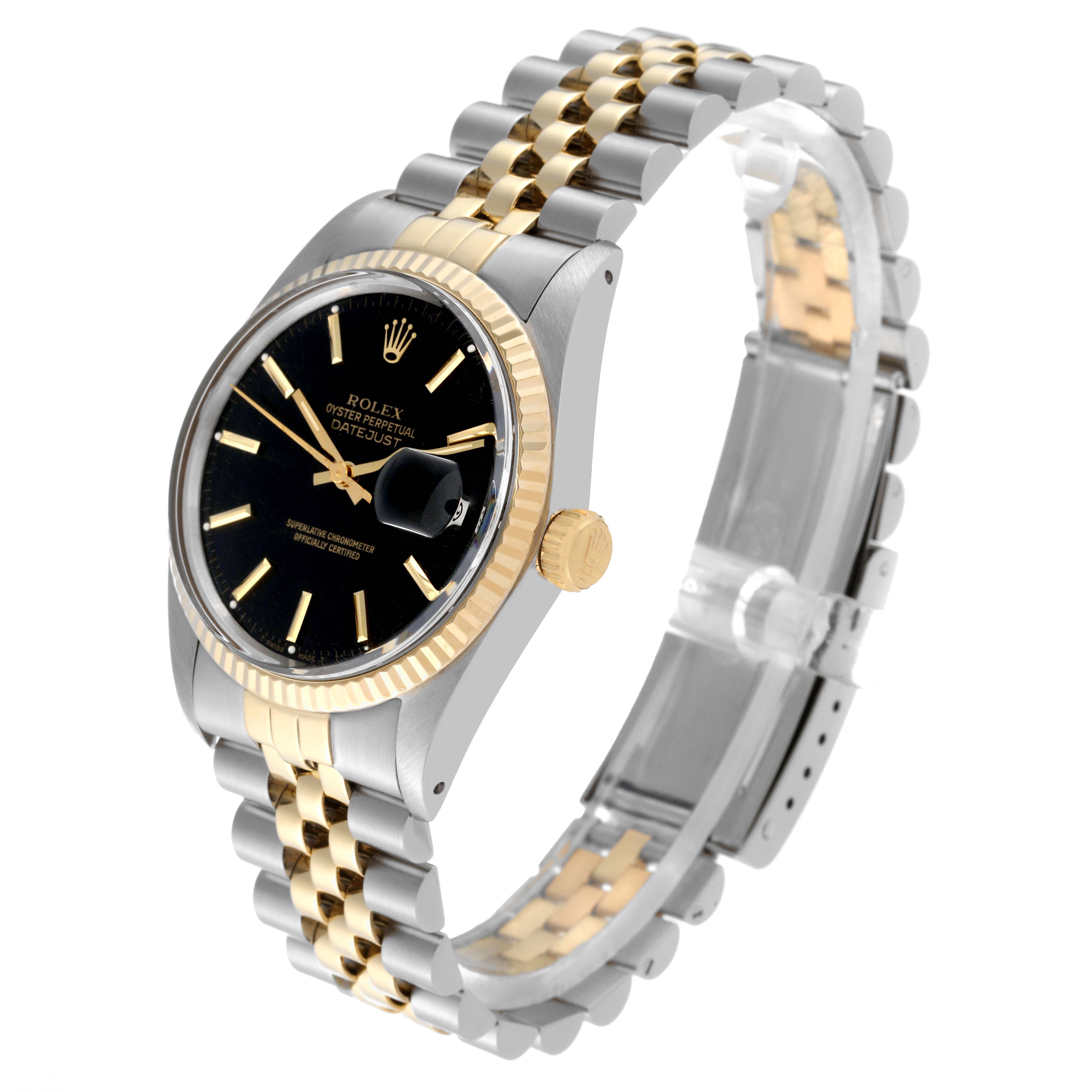 The image shows a Rolex Datejust 16013 Men's Steel and Gold (two tone) Black Dial 16013 Men's Steel and Gold (two tone) Black Dial watch at an angled side view, highlighting its black dial, fluted bezel, and two-tone bracelet.