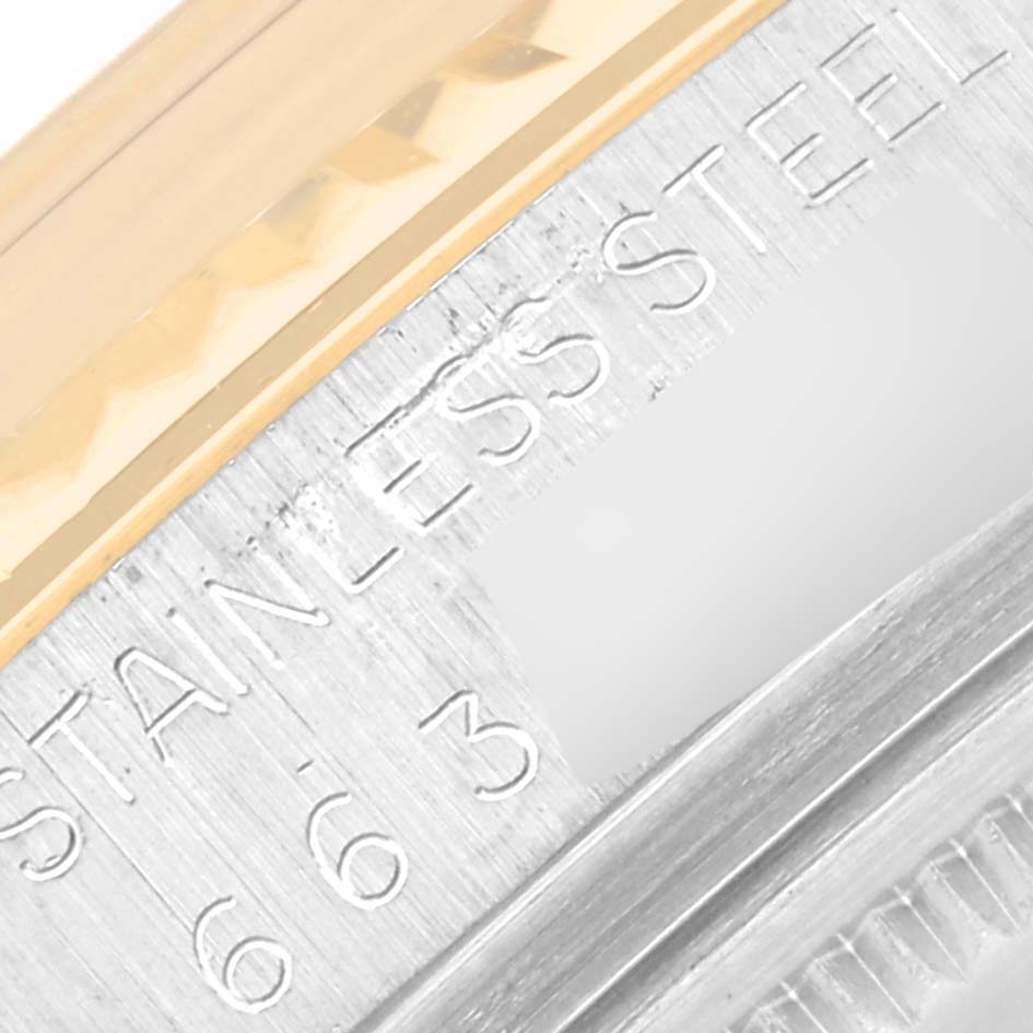 The image shows a close-up of the stainless steel and gold bezel with engraving from the Rolex Datejust 16013 Men's Steel and Gold (two tone) Black Dial 16013 Men's Steel and Gold (two tone) Black Dial model.