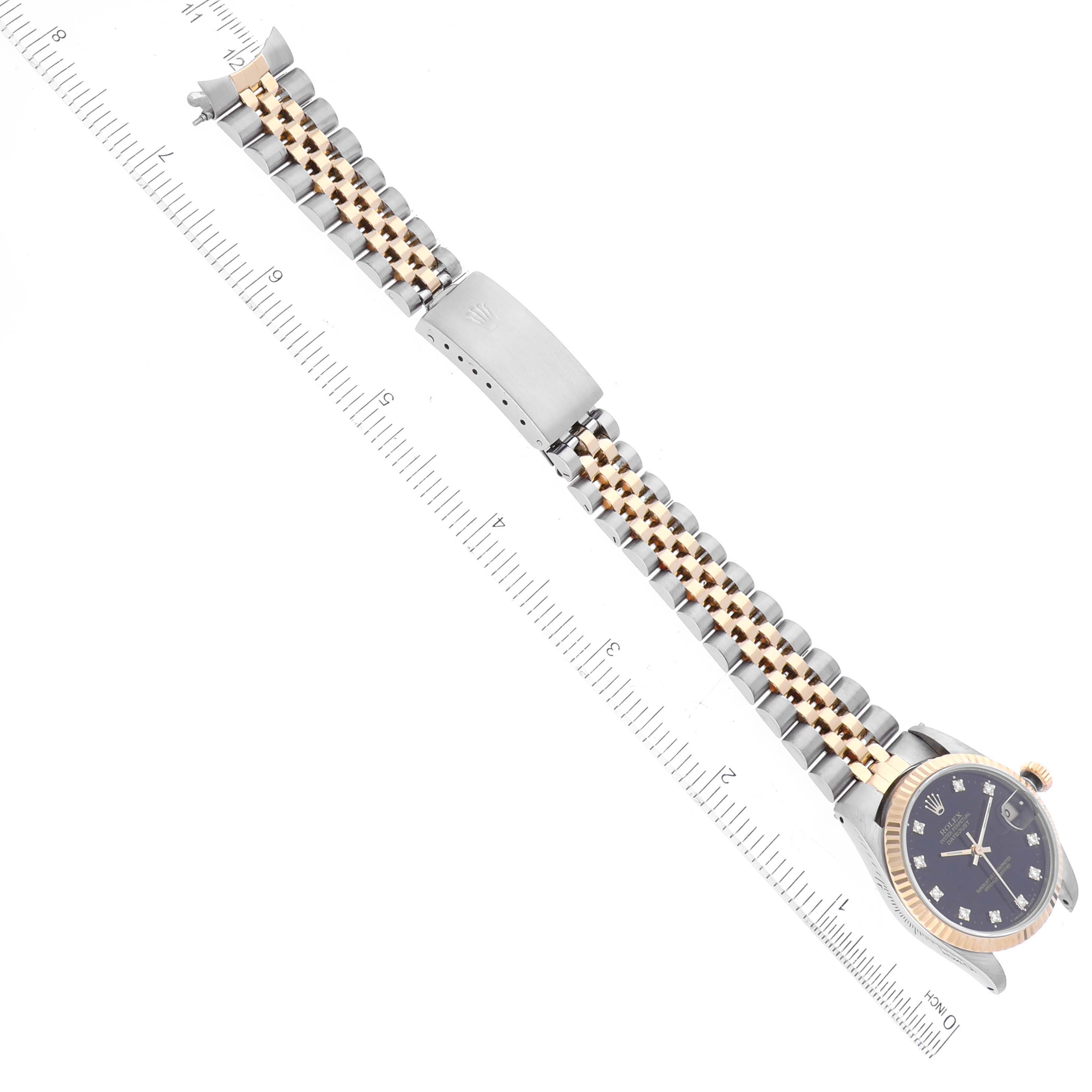 The image shows a Rolex Mid-Size 68273 Women's Steel and Gold (two tone) Black Dial 68273 Women's Steel and Gold (two tone) Black Dial model watch, displayed horizontally with a measuring scale, showcasing the watch face and bracelet.