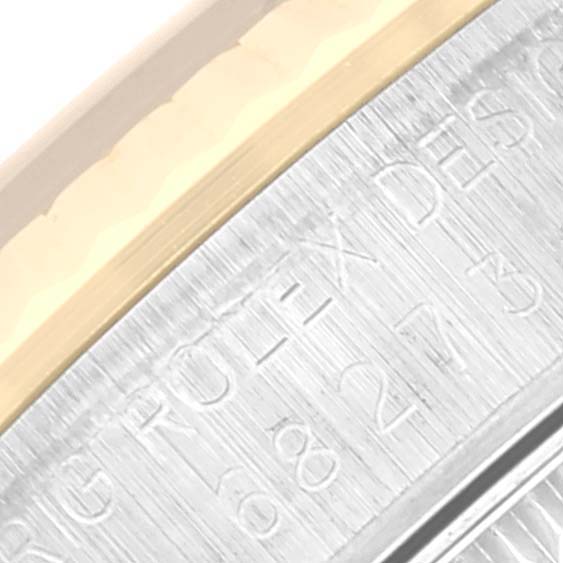 The image shows a close-up view of the bezel and part of the engravings on the Mid-Size Rolex watch.