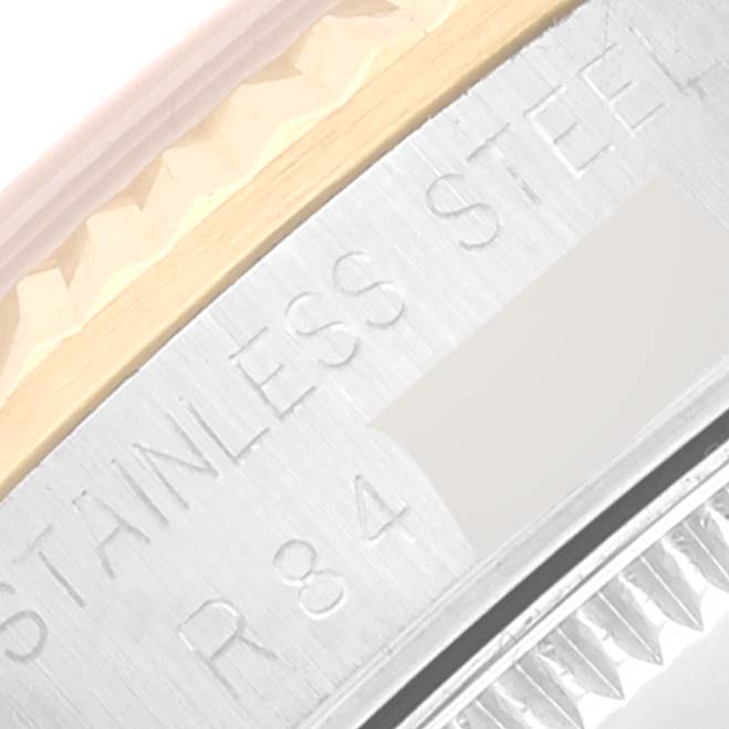 This close-up of a mid-size Rolex watch shows a portion of the case engraving, including the "STAINLESS STEEL" text.