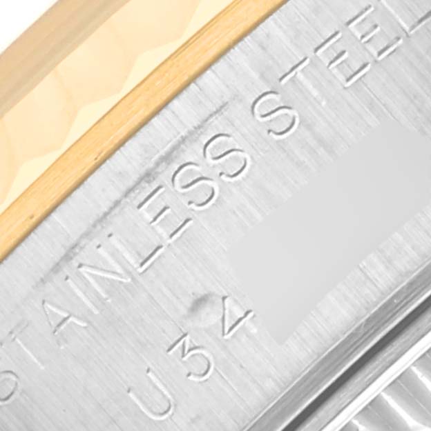 This close-up image of the Rolex Datejust 69173 Women's Steel and Gold (two tone) Mother of Pearl Dial 69173 Women's Steel and Gold (two tone) Mother of Pearl Dial watch shows part of the stainless steel and gold bezel along with the engraved text.