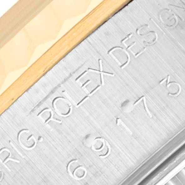 Close-up of the Rolex Datejust 69173 Women's Steel and Gold (two tone) Mother of Pearl Dial 69173 Women's Steel and Gold (two tone) Mother of Pearl Dial case edge displaying the engraved "ROLEX DESIGN" and a portion of the gold bezel.